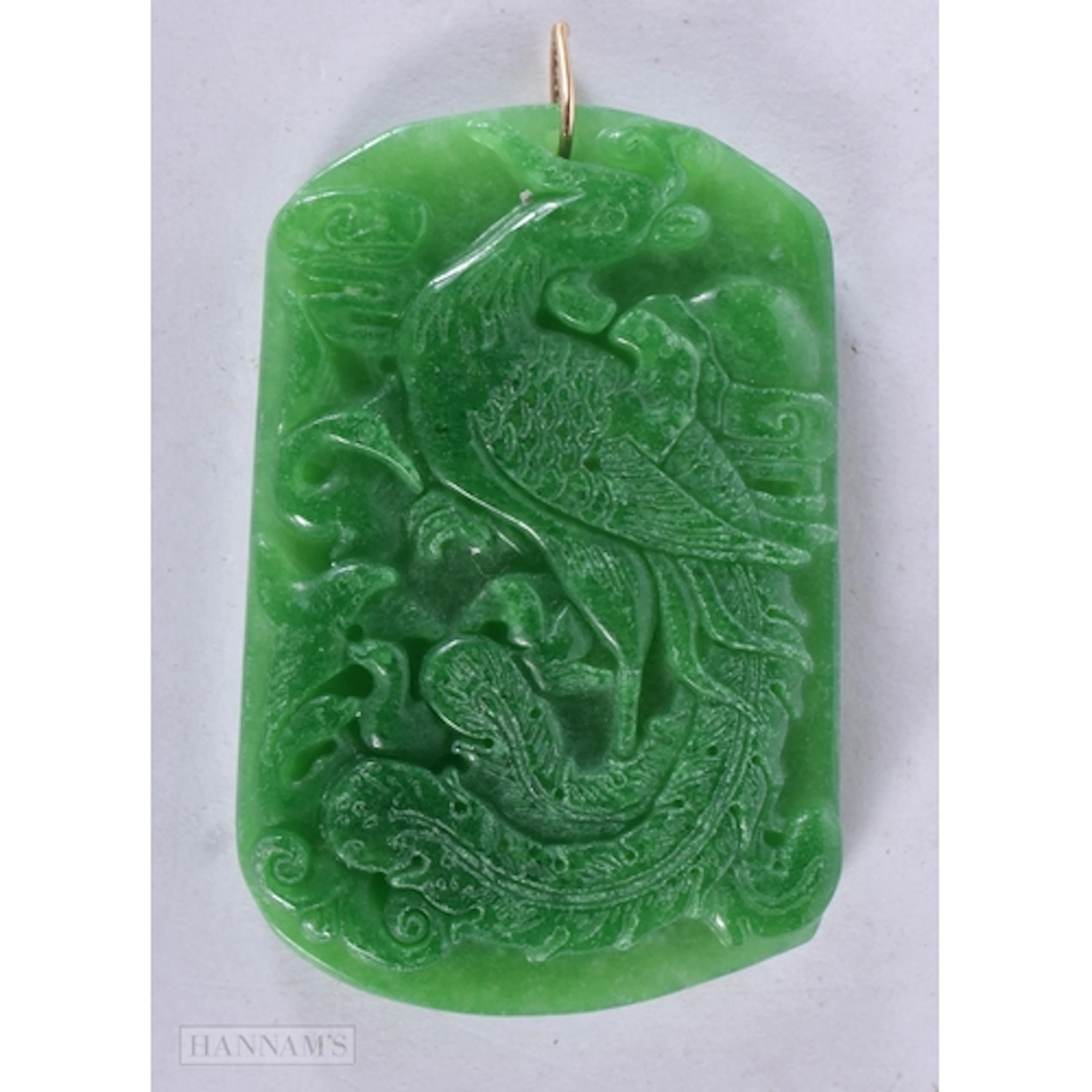 A CHINESE GOLD MOUNTED DRAGON PENDANT. 6.5 cm x 4.5 cm.