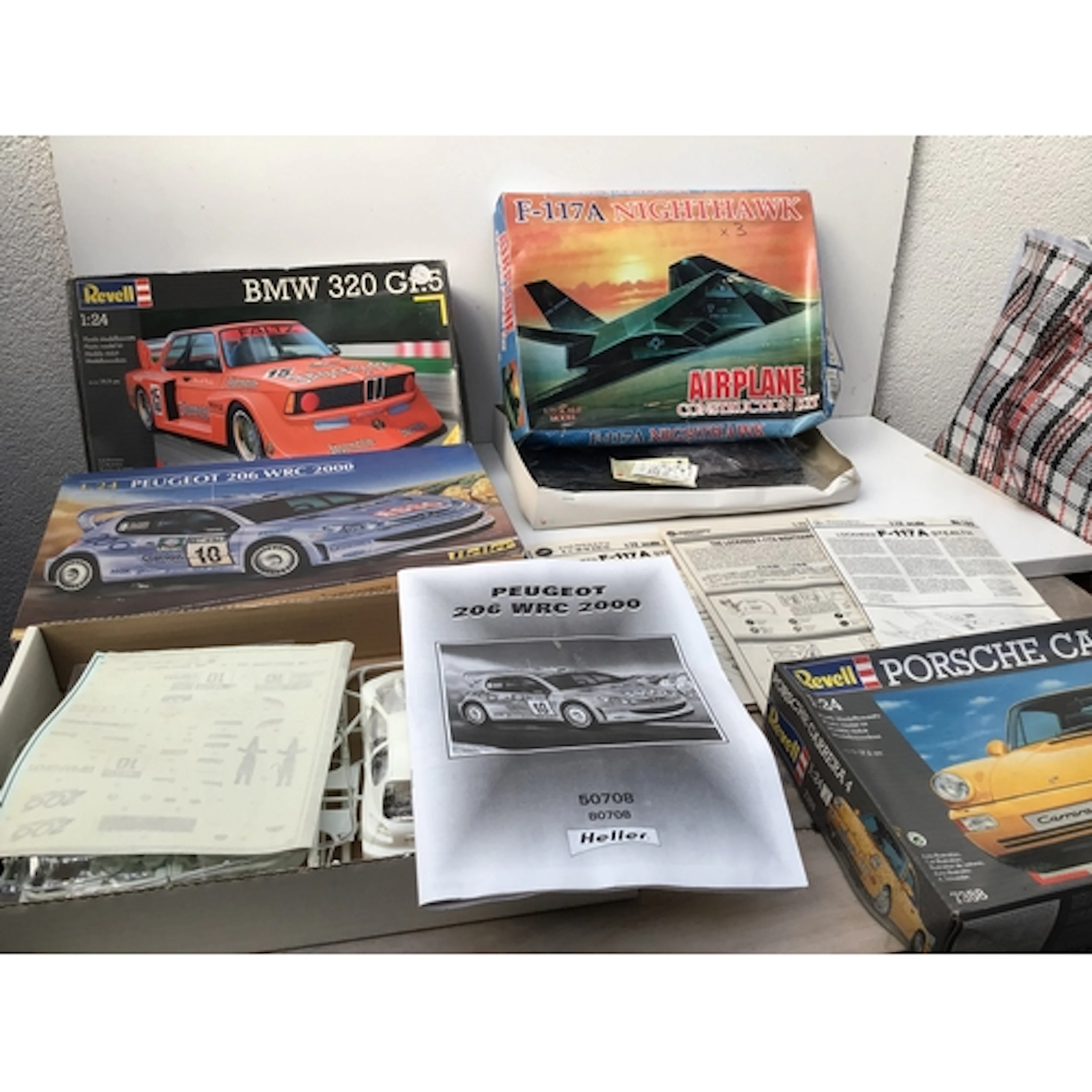 A box containing a collection of boxed model kits featuring ...
