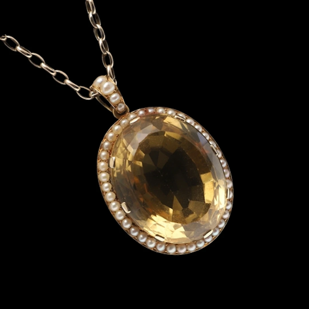 A CITRINE AND CULTURED PEARL PENDANT. the large oval-shaped ...