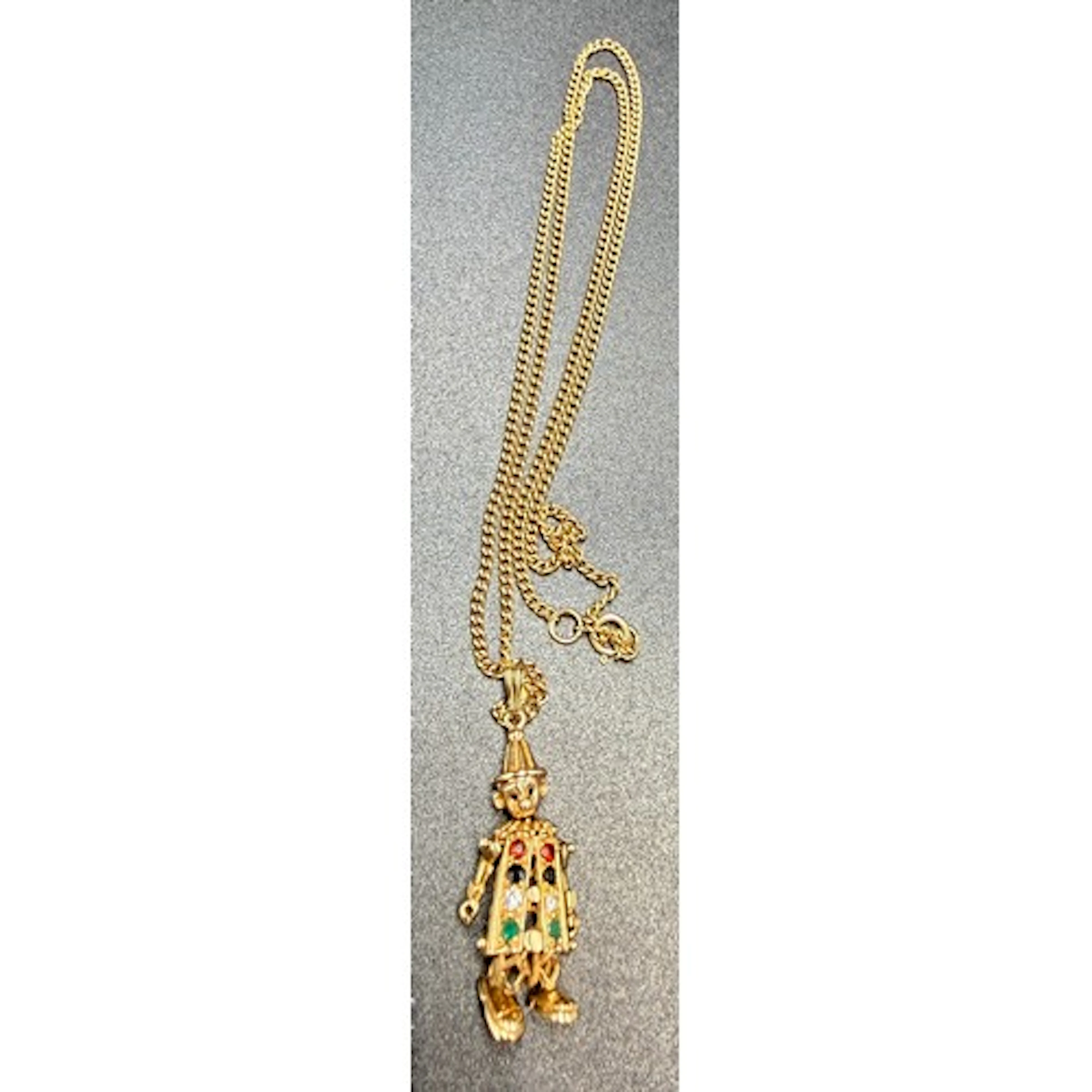 A 9 carat gold gem set articulated clown pendant suspended o...