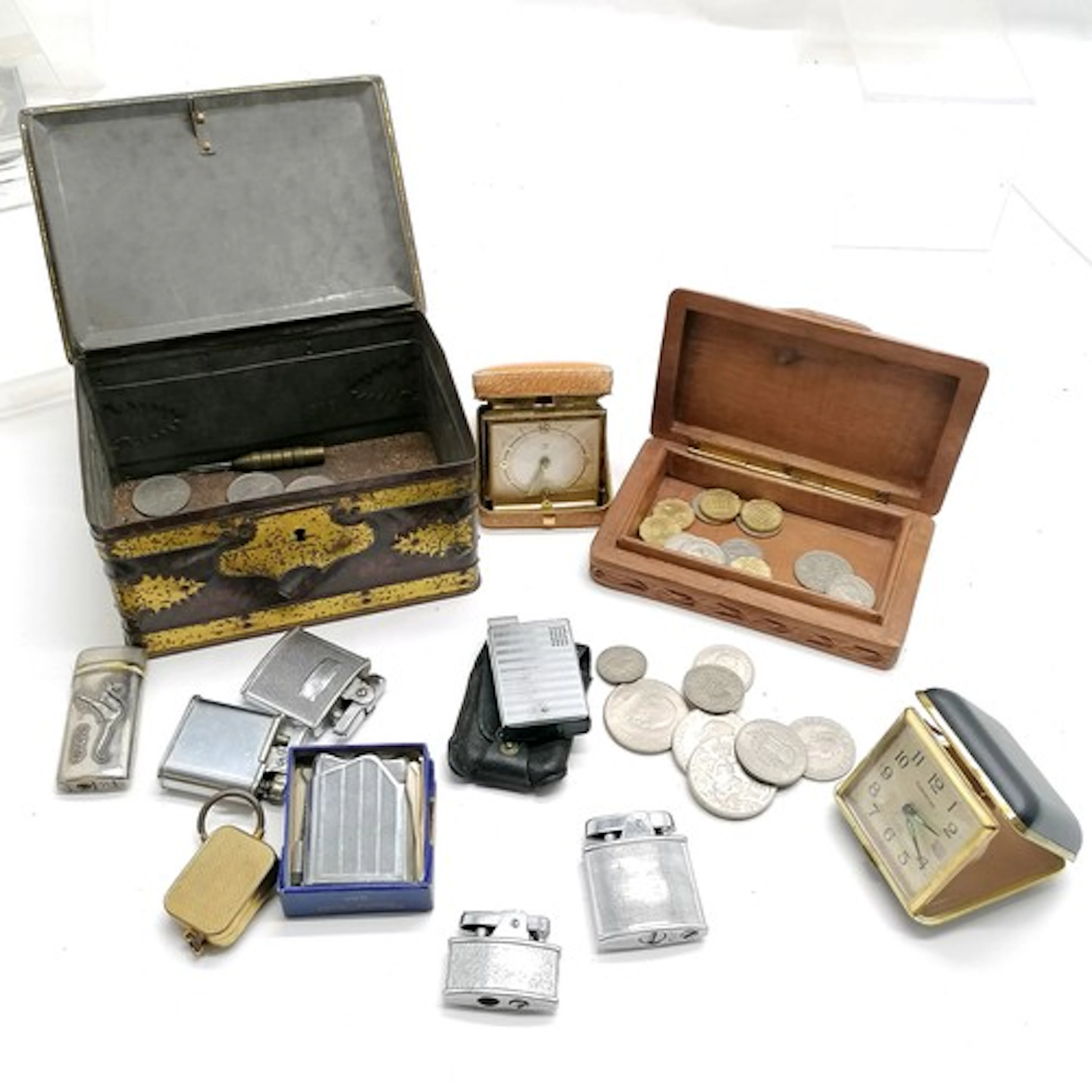 Vintage biscuit tin containing travel clocks, lighters etc t...