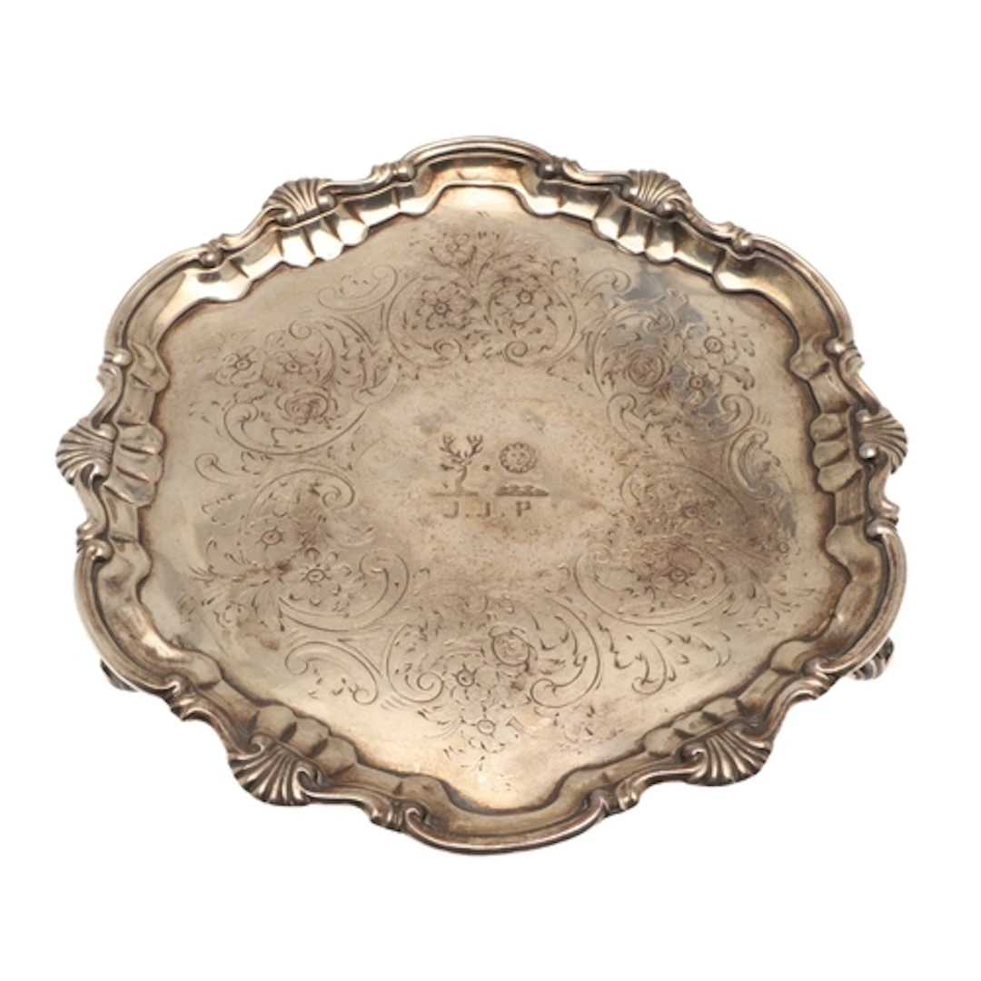 A GEORGE II SILVER SALVER. Of circular form with moulded she...
