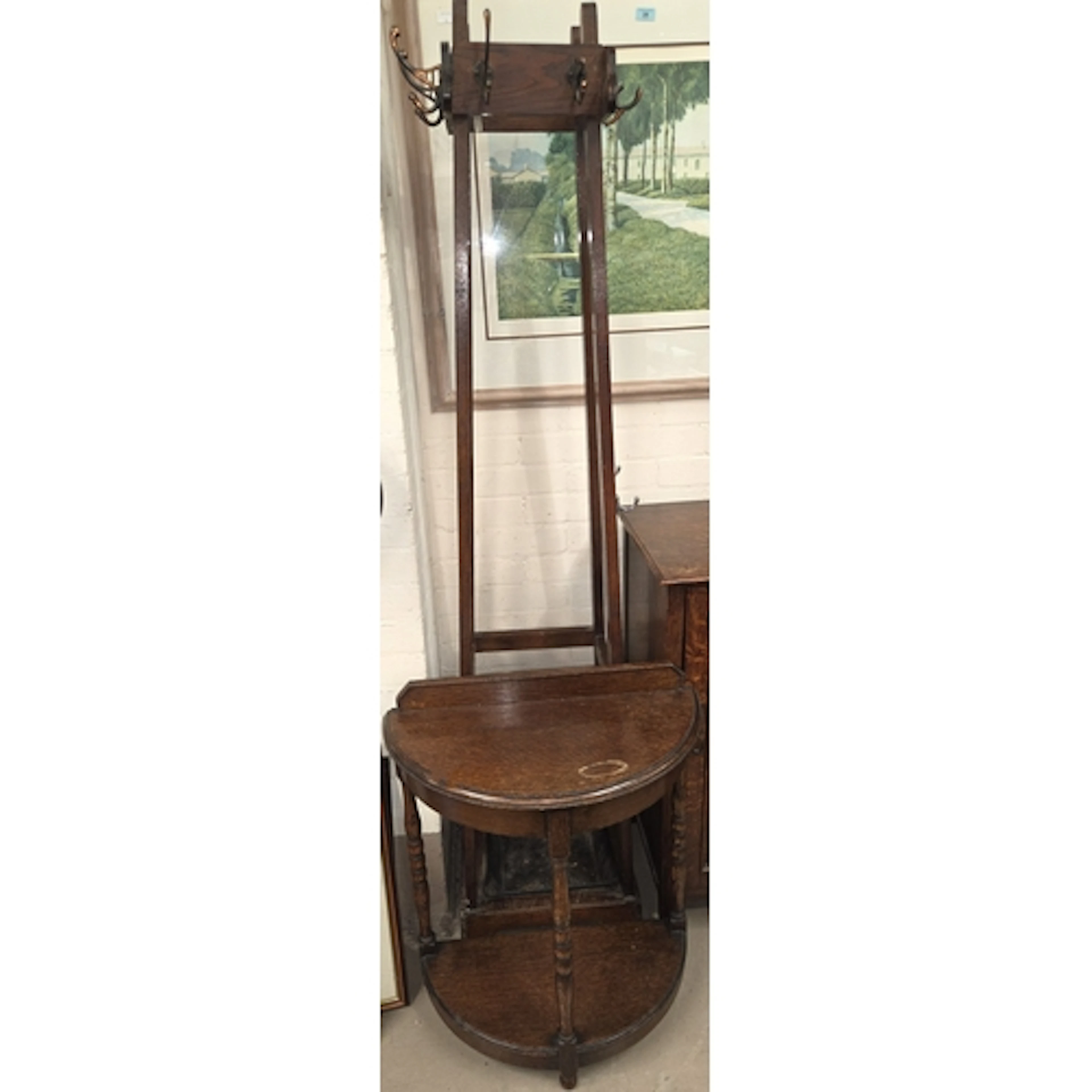 A 1930's oak hat and coat stand with central stick area, an ...