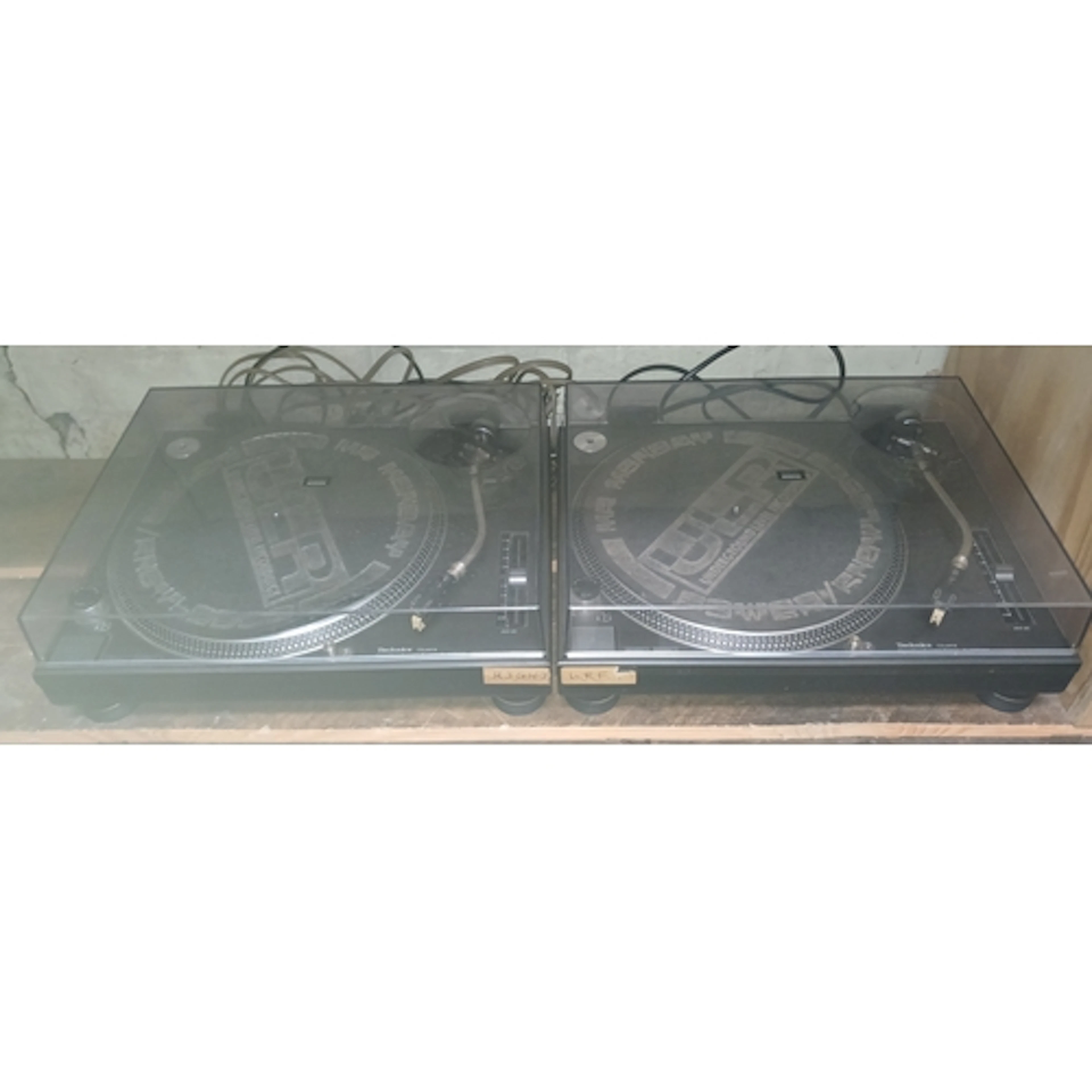 A pair of Technics SL-1210MK2 turntables with boxes.