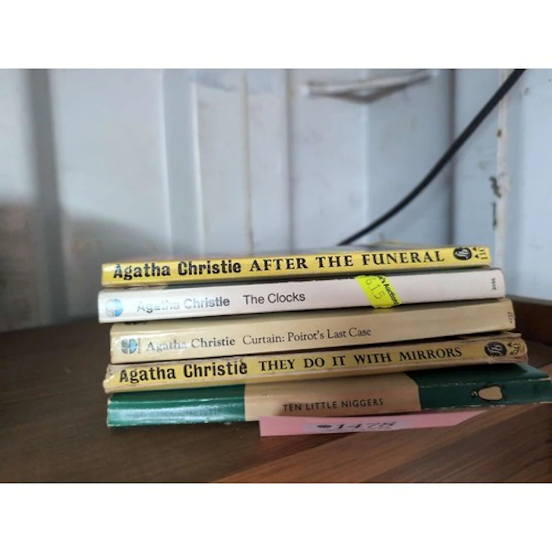 Five Agatha Christie paperbacks.