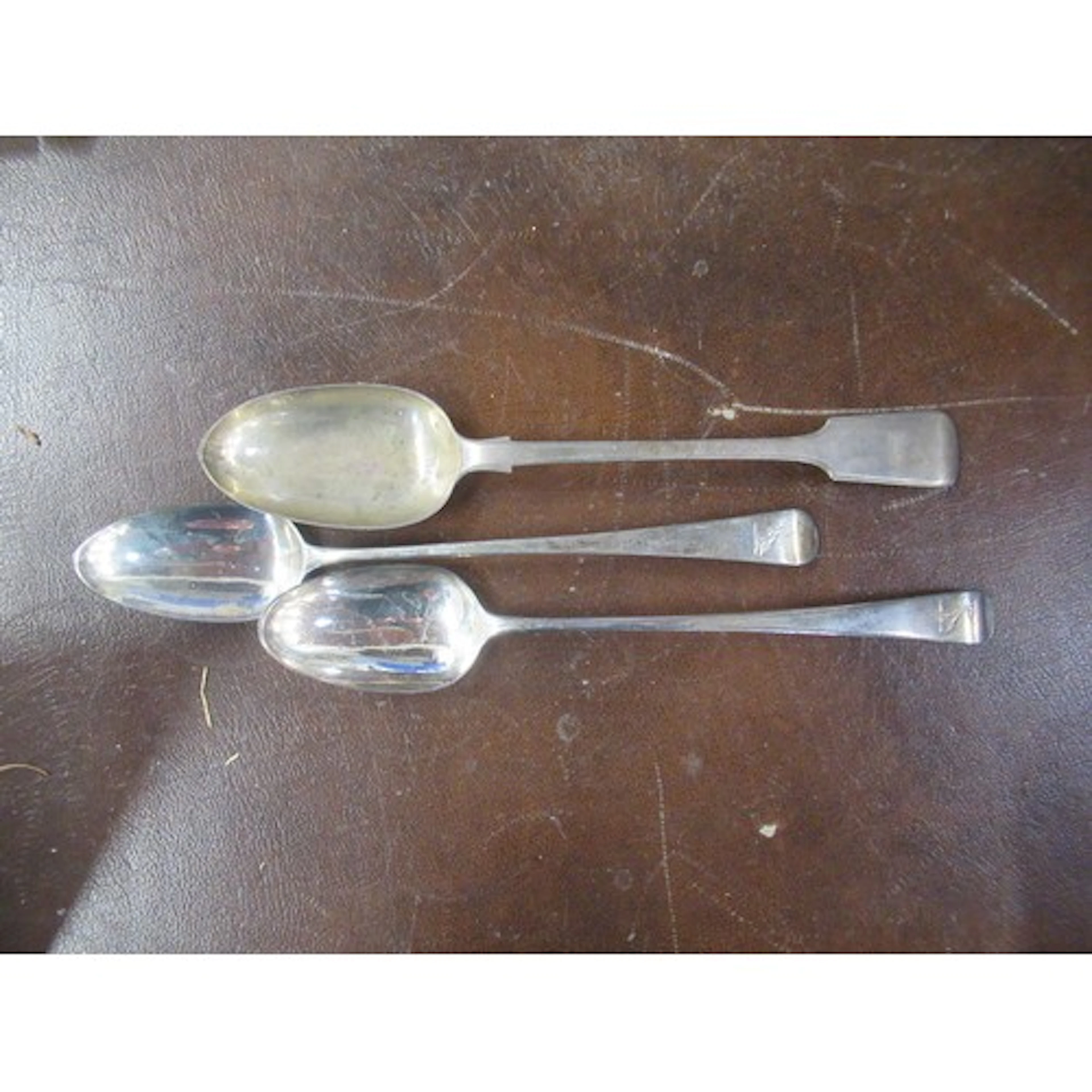Three 19th century silver basting spoons, all engraved with ...