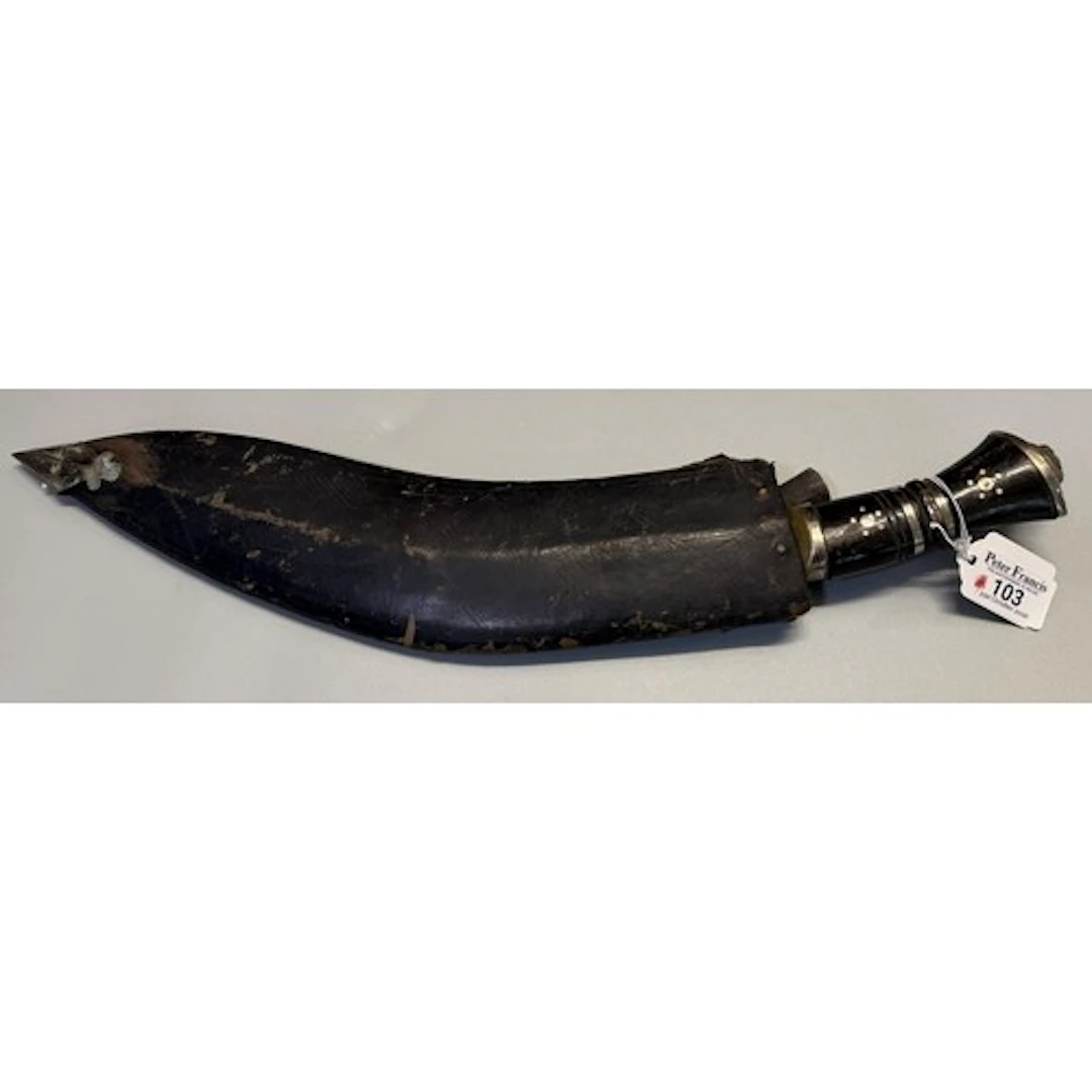 Nepalese Kukri with lion’s-head pommel, in a leather-covered...