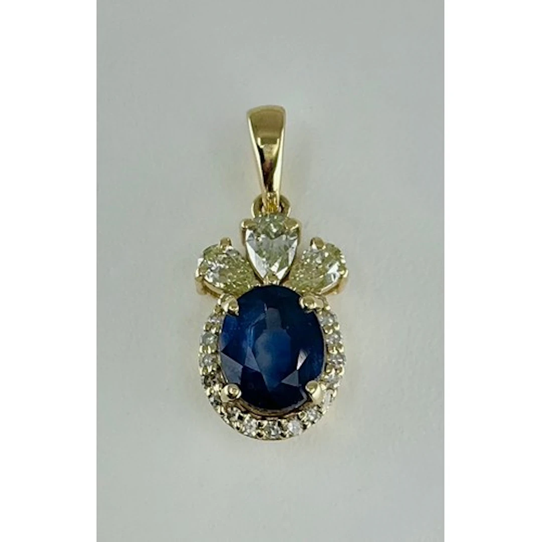 A sapphire and diamond cluster pendant, central blue oval mi...