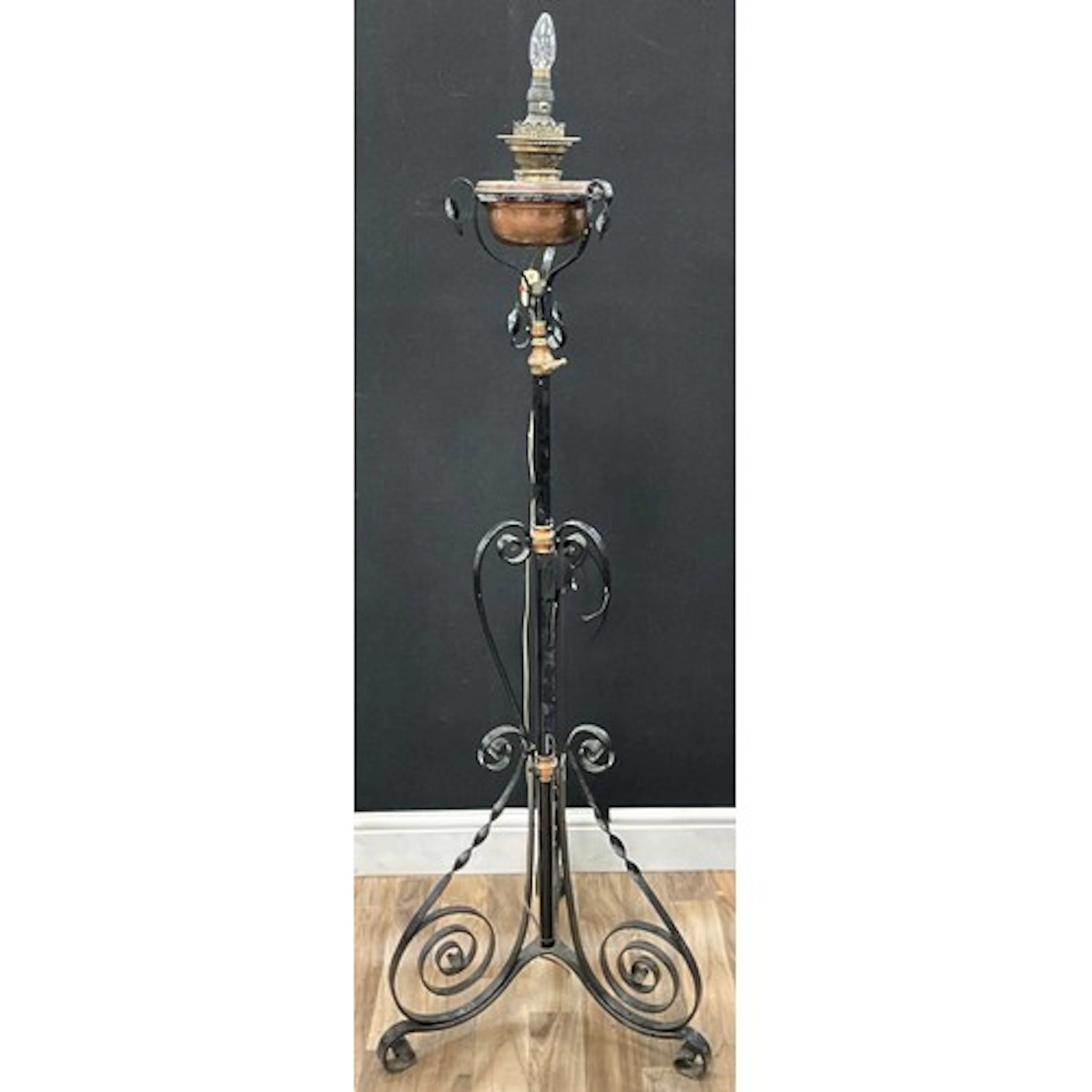 An arts and crafts wrought iron and copper floor standing oi...