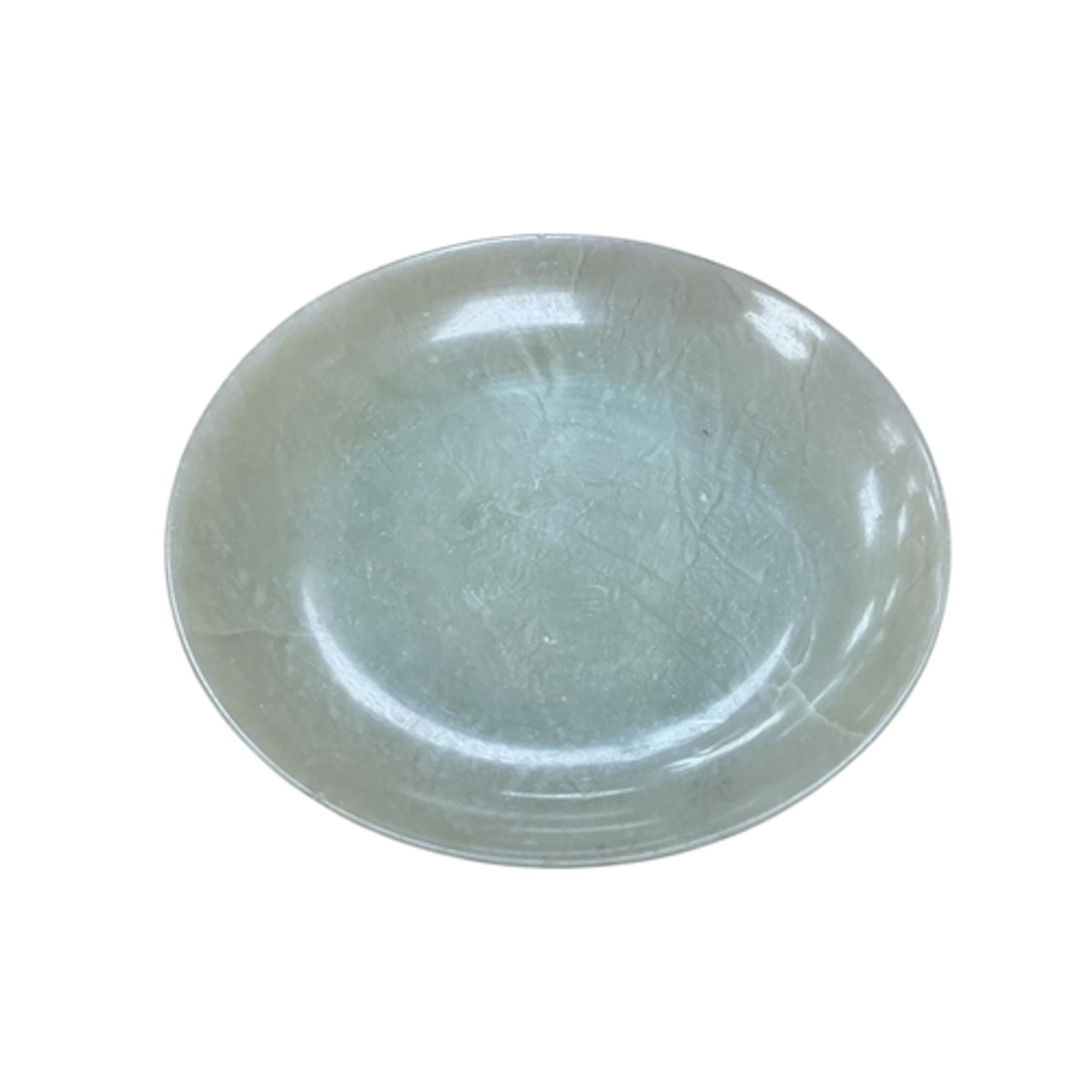 A Chinese bowenite jade saucer dish, on a circular foot, 12....