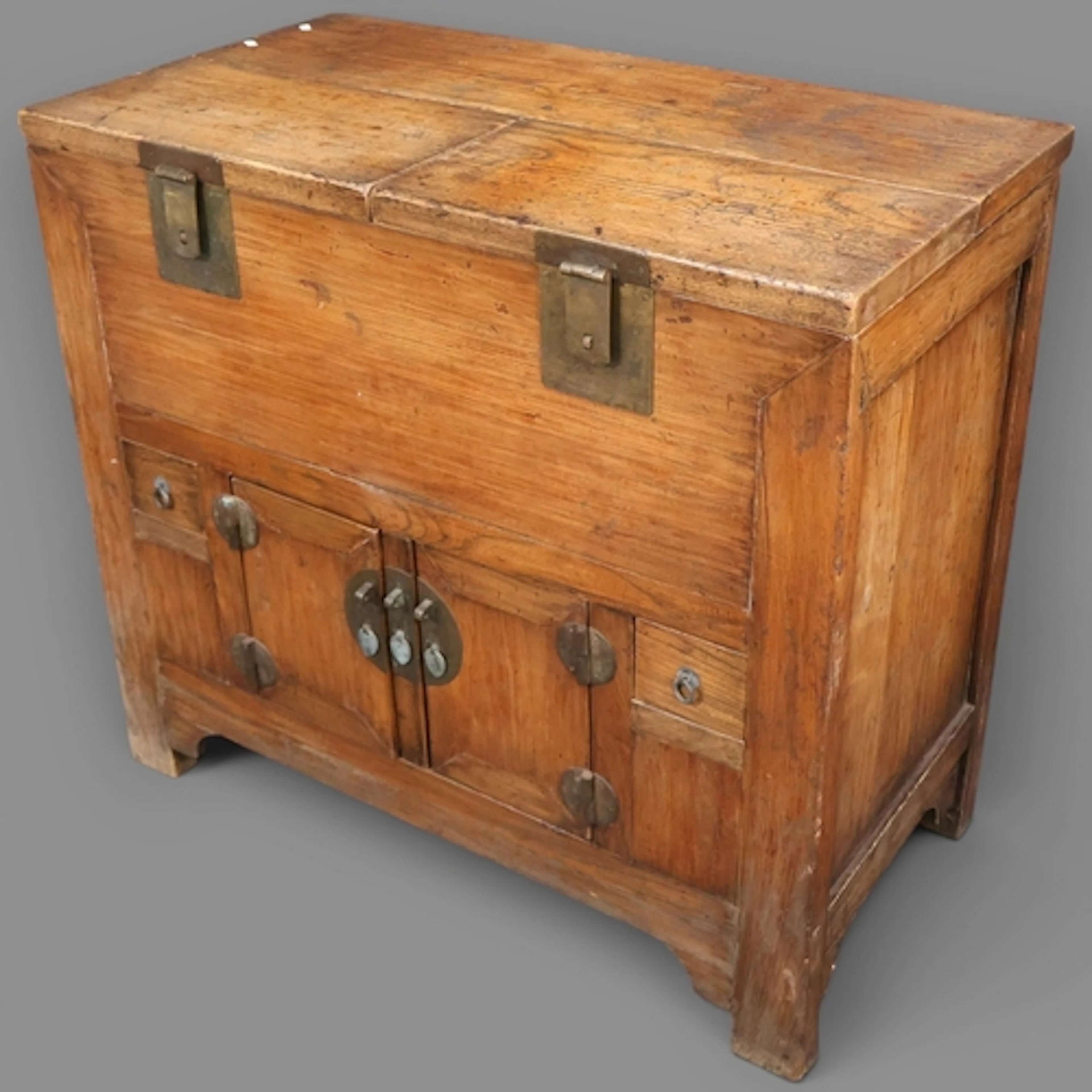 A Chinese elm money trunk, with two lifting lids, two doors ...