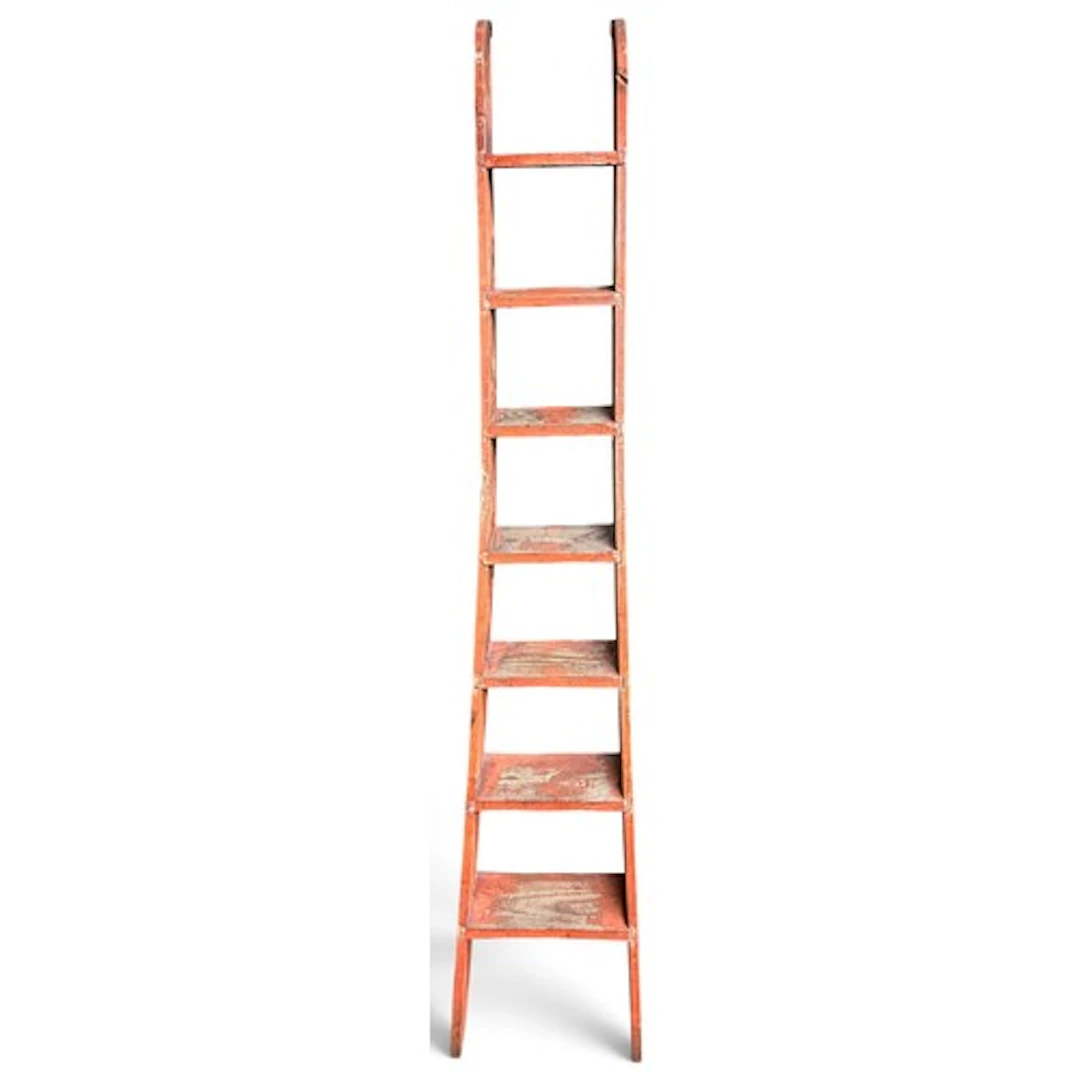 A tall red stained pine library ladder, of tapering form, 19...