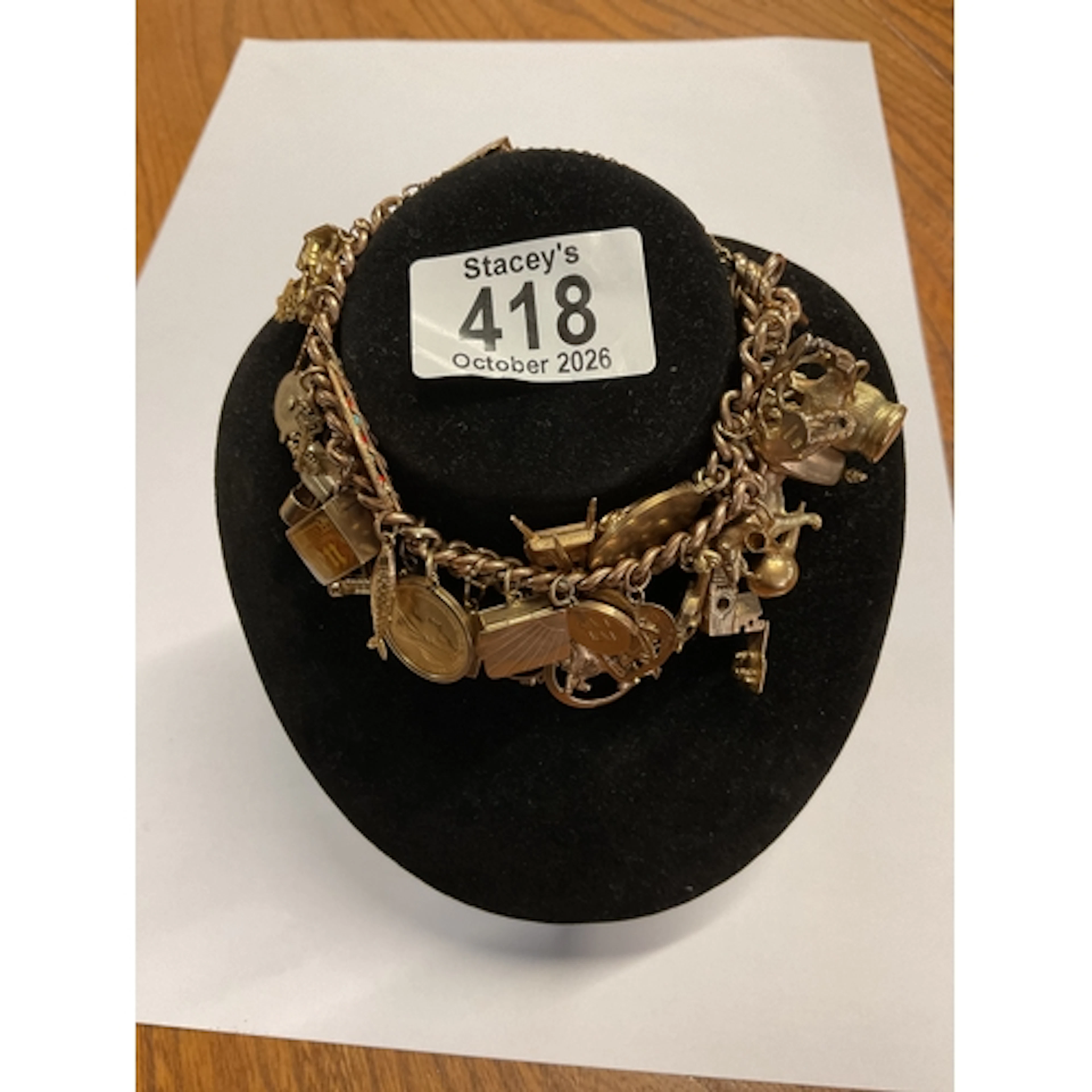 Heavy gold charm bracelet, with a half sovereign, weight 92....