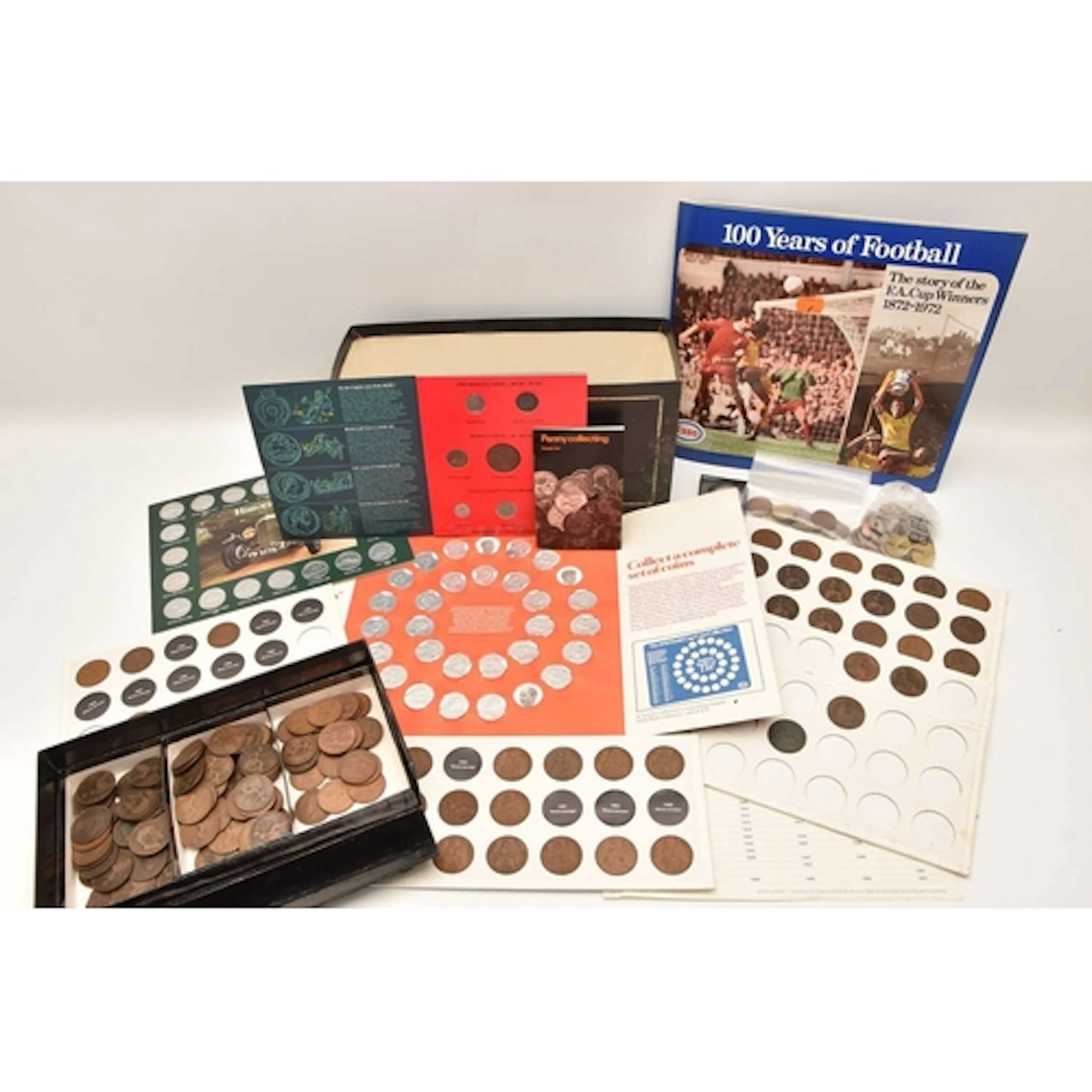 A cardboard box containing a large amount of coins, includin...