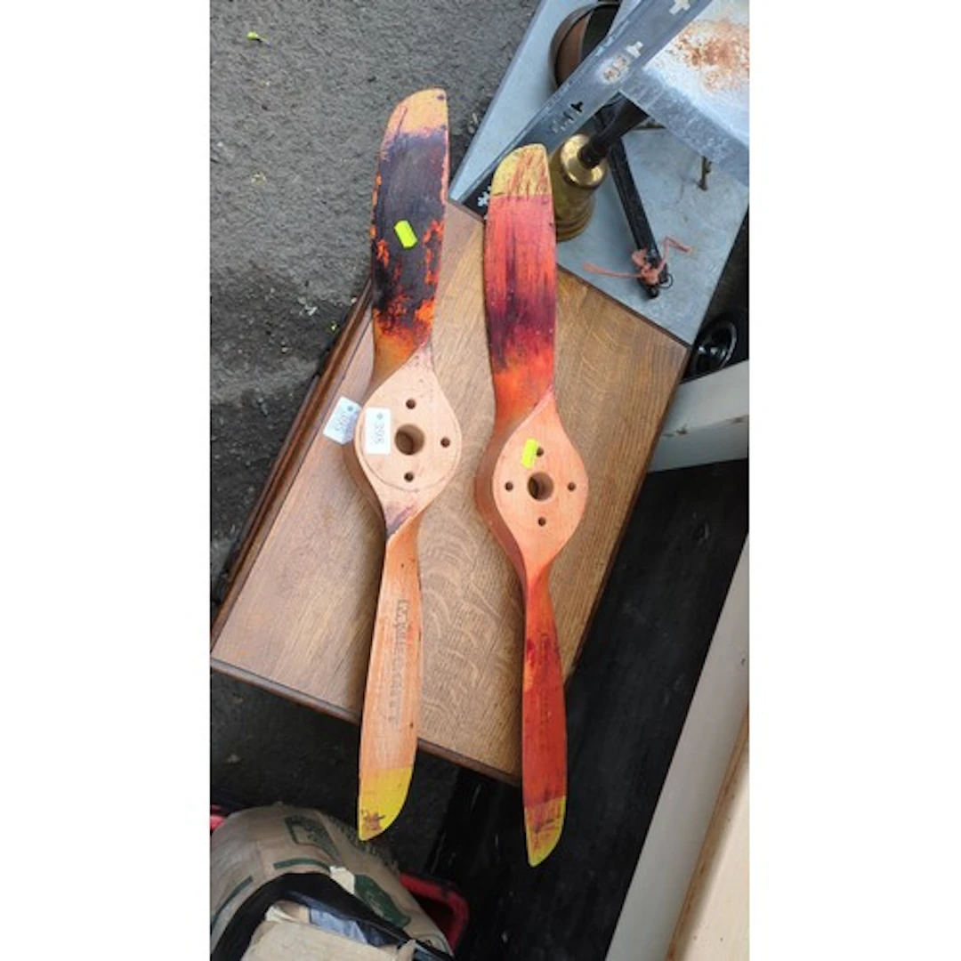 A pair of wooden two-blade aircraft propellers, each with a ...