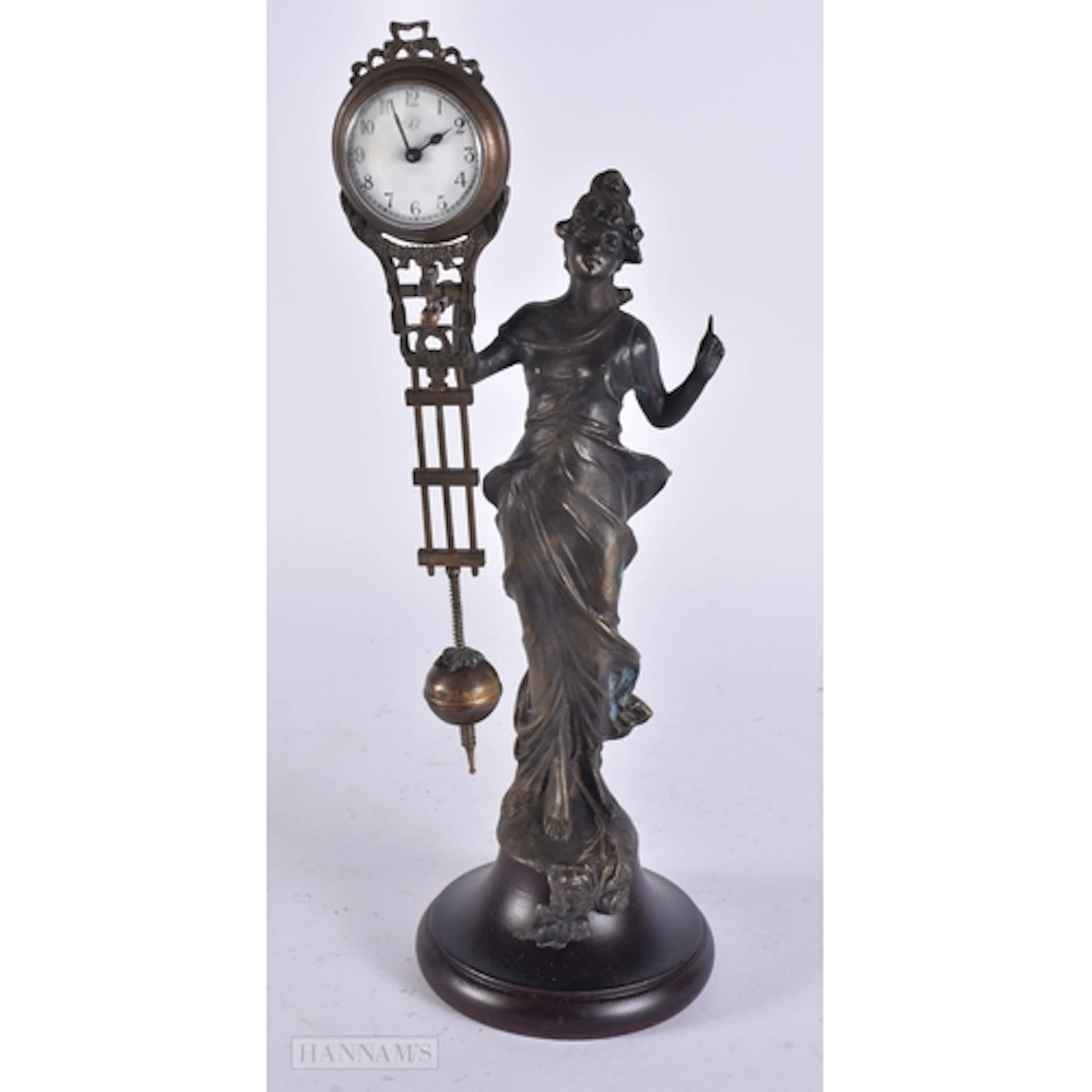 A BRONZE MYSTERY CLOCK. 30cm high.