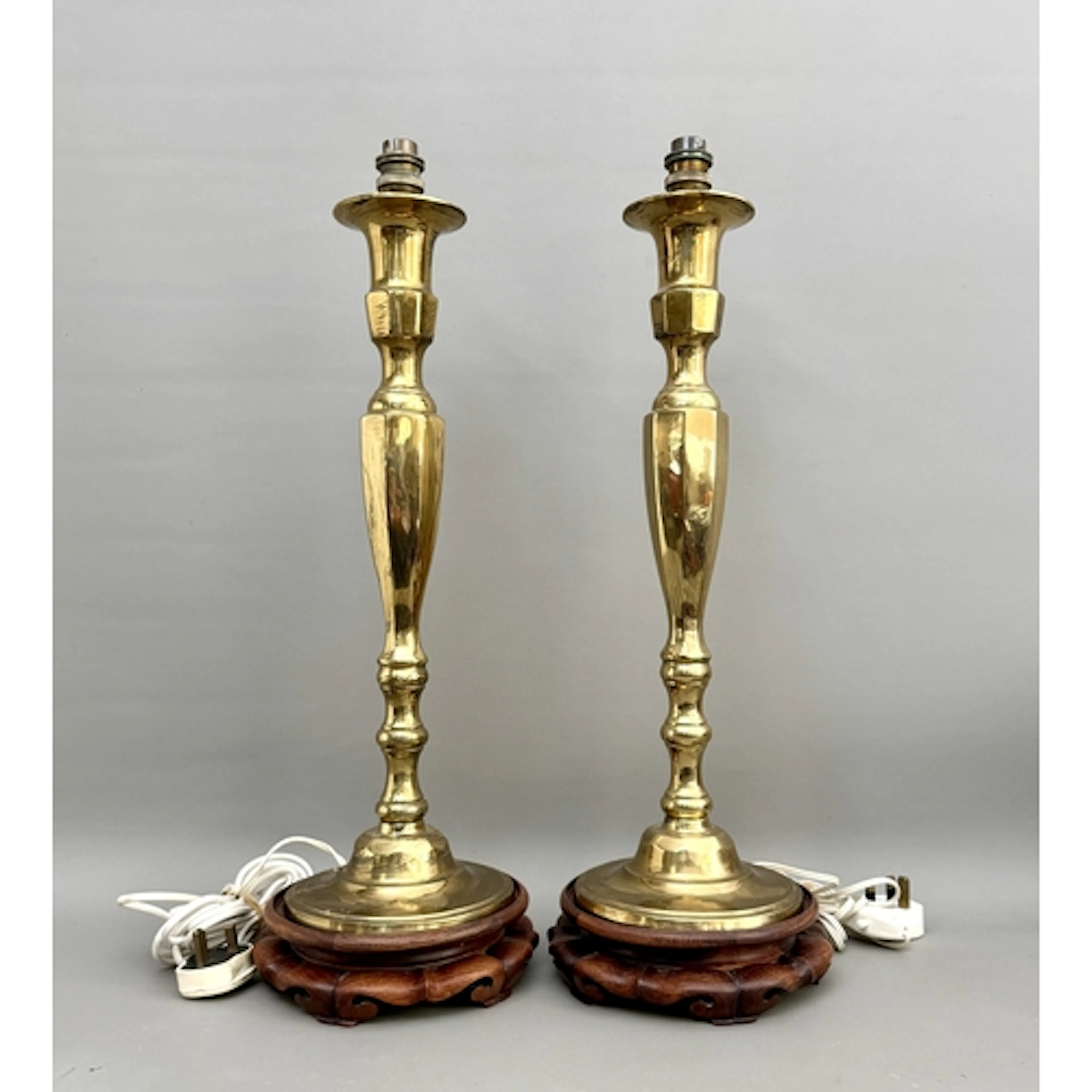 A pair of tall brass candlestick-form table-lamp bases - on ...