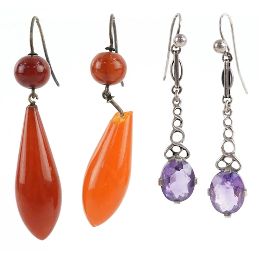 Two pairs of drop earrings comprising a pair of amber colour...