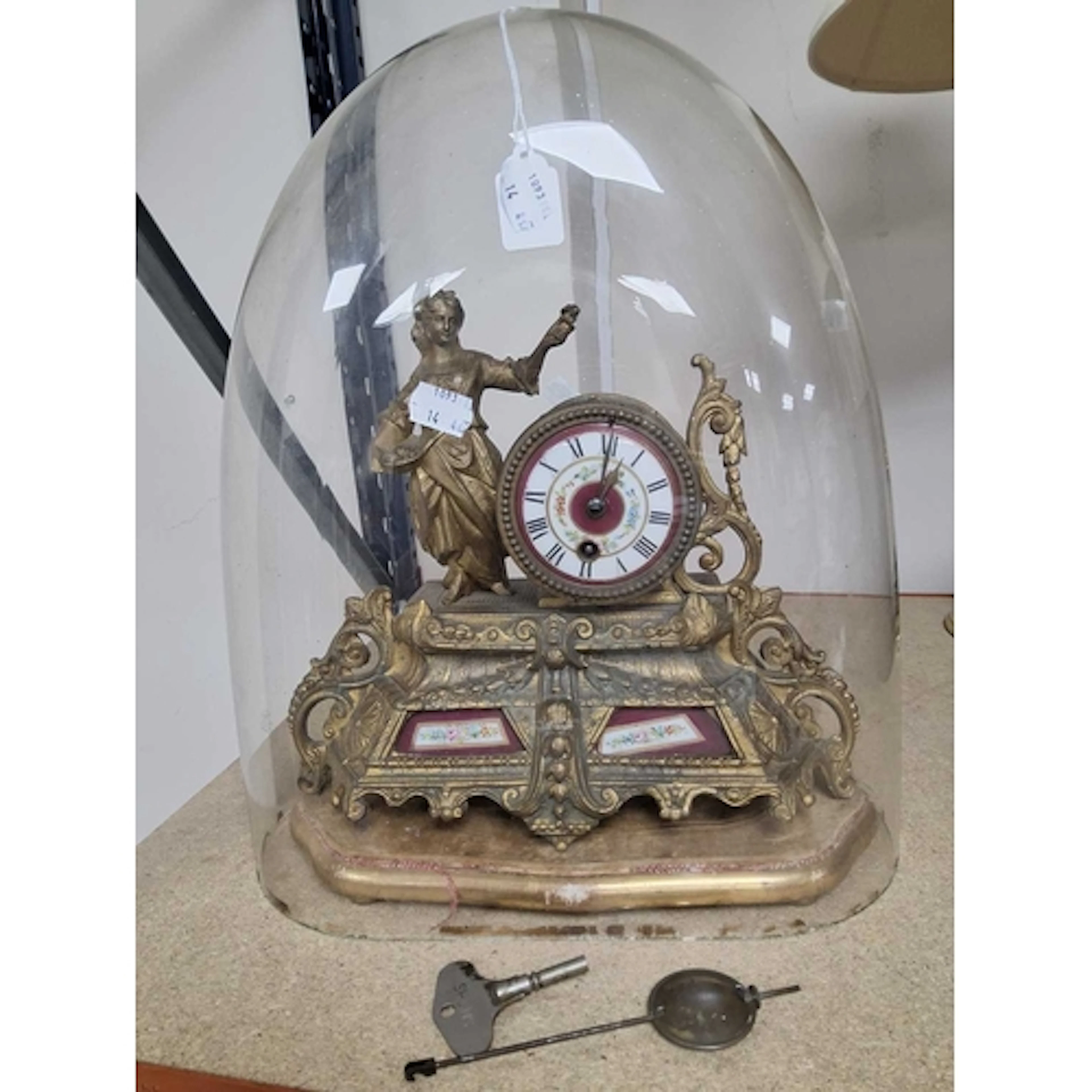 A GILT METAL FIGURAL MANTEL CLOCK, the rococo style clock ca...
