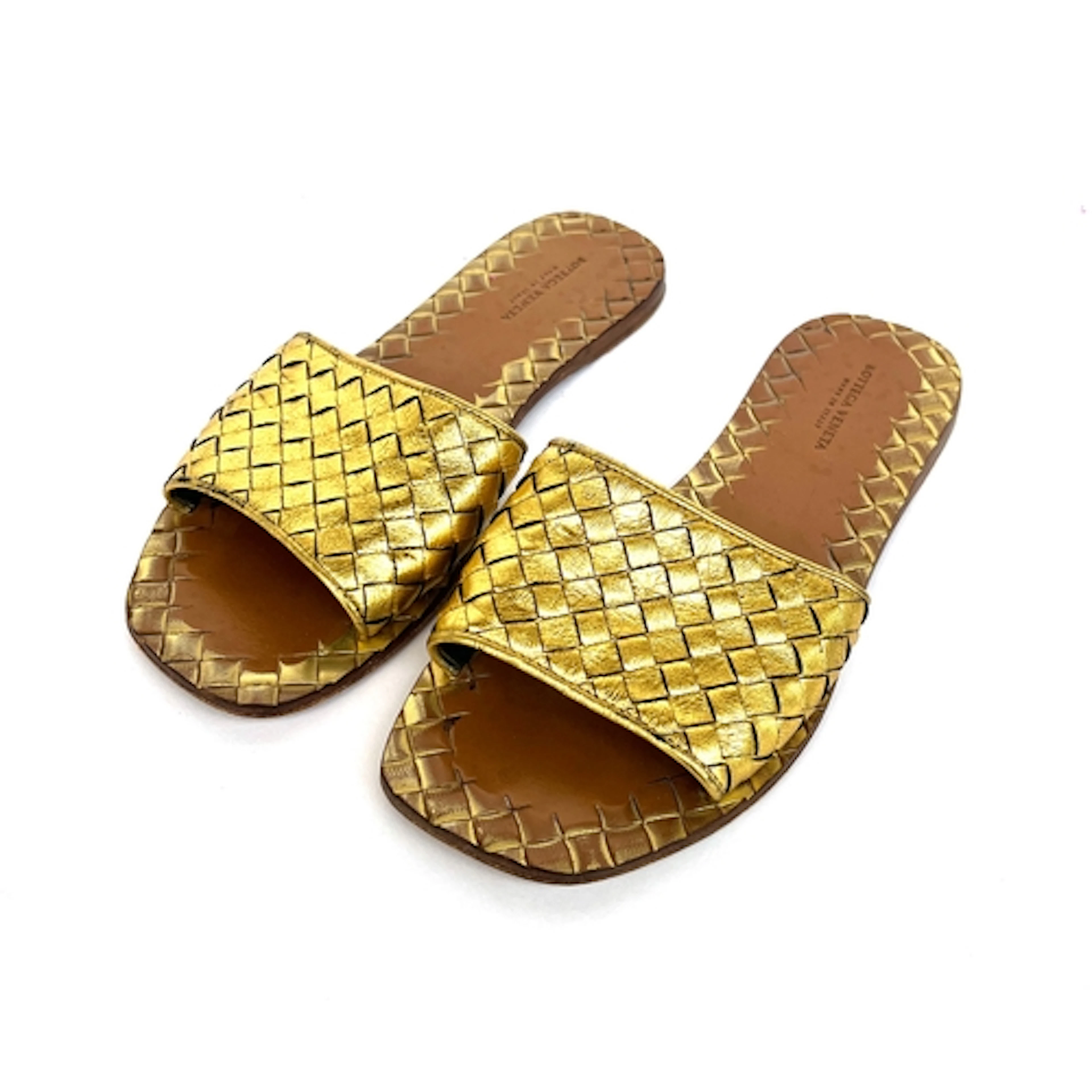 A pair of Bottega Veneta gold intrecciato woven leather mule...