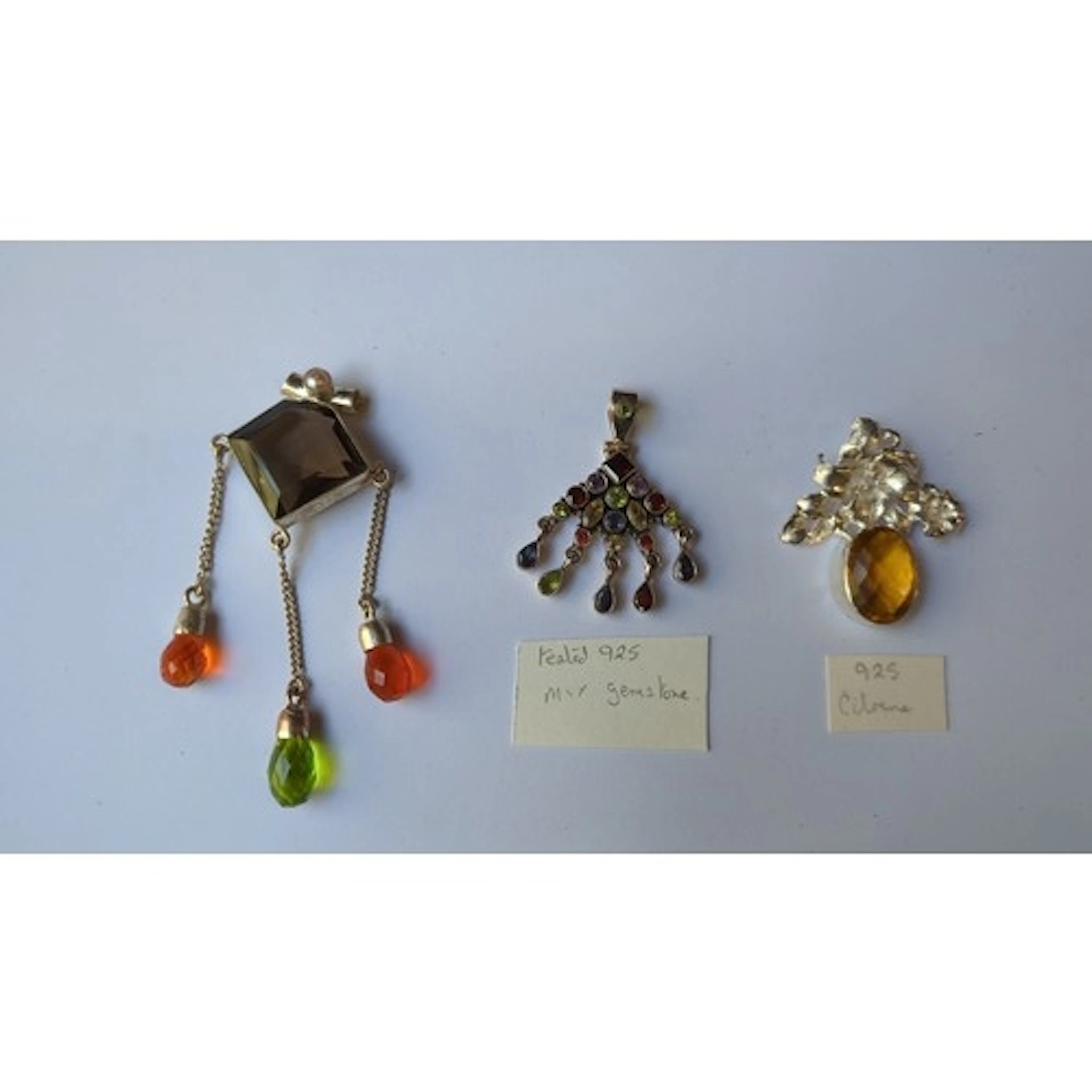 A group of 925 silver gemstone pendants: one set with a squa...