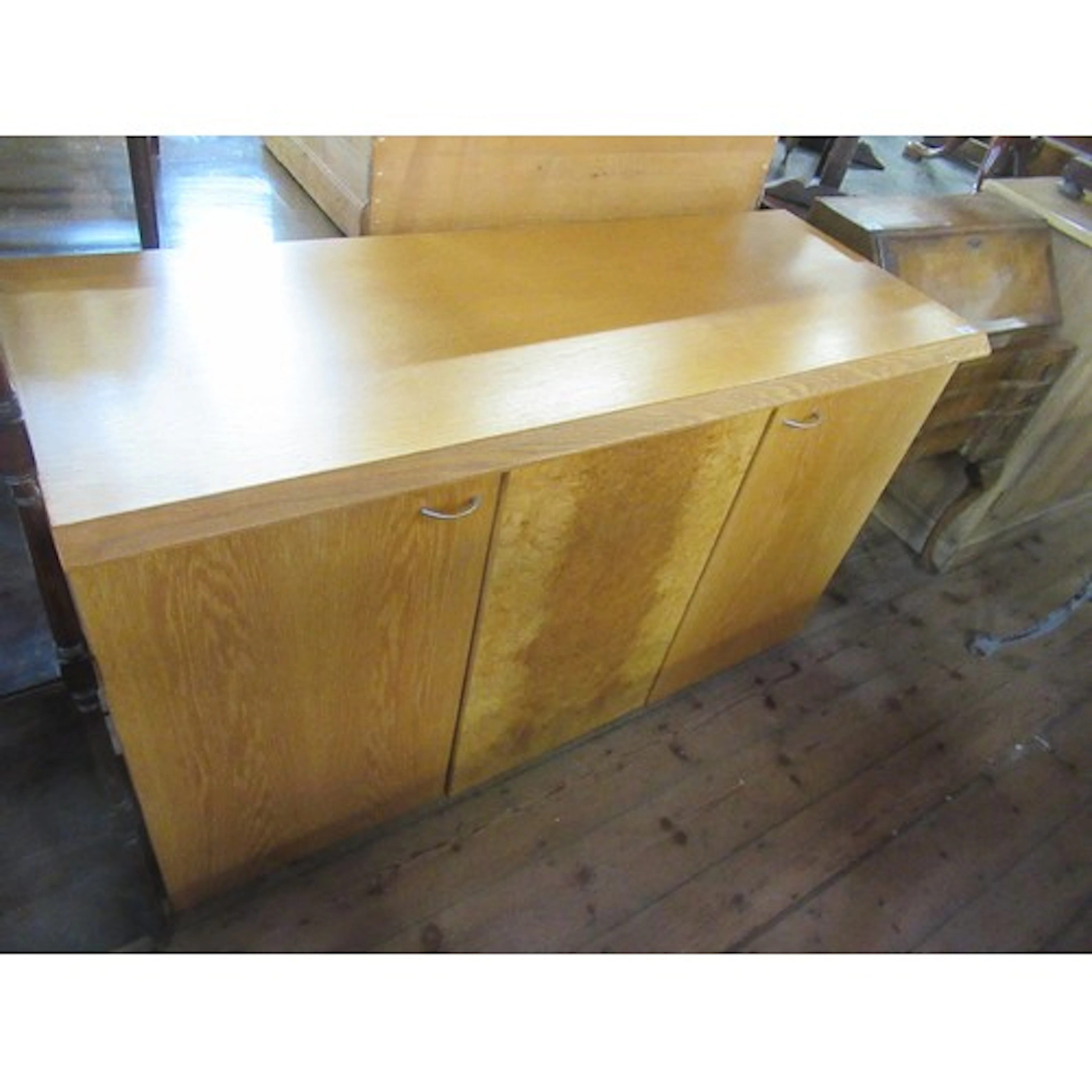 A contemporary Art Deco style oak sideboard, having central ...