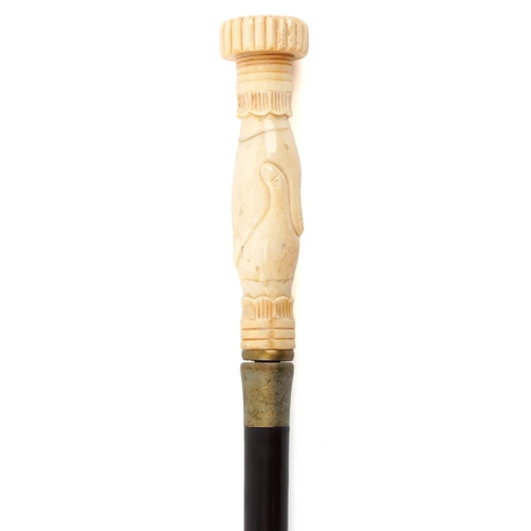 Hardwood walking stick with bone handle in the form of holdi...