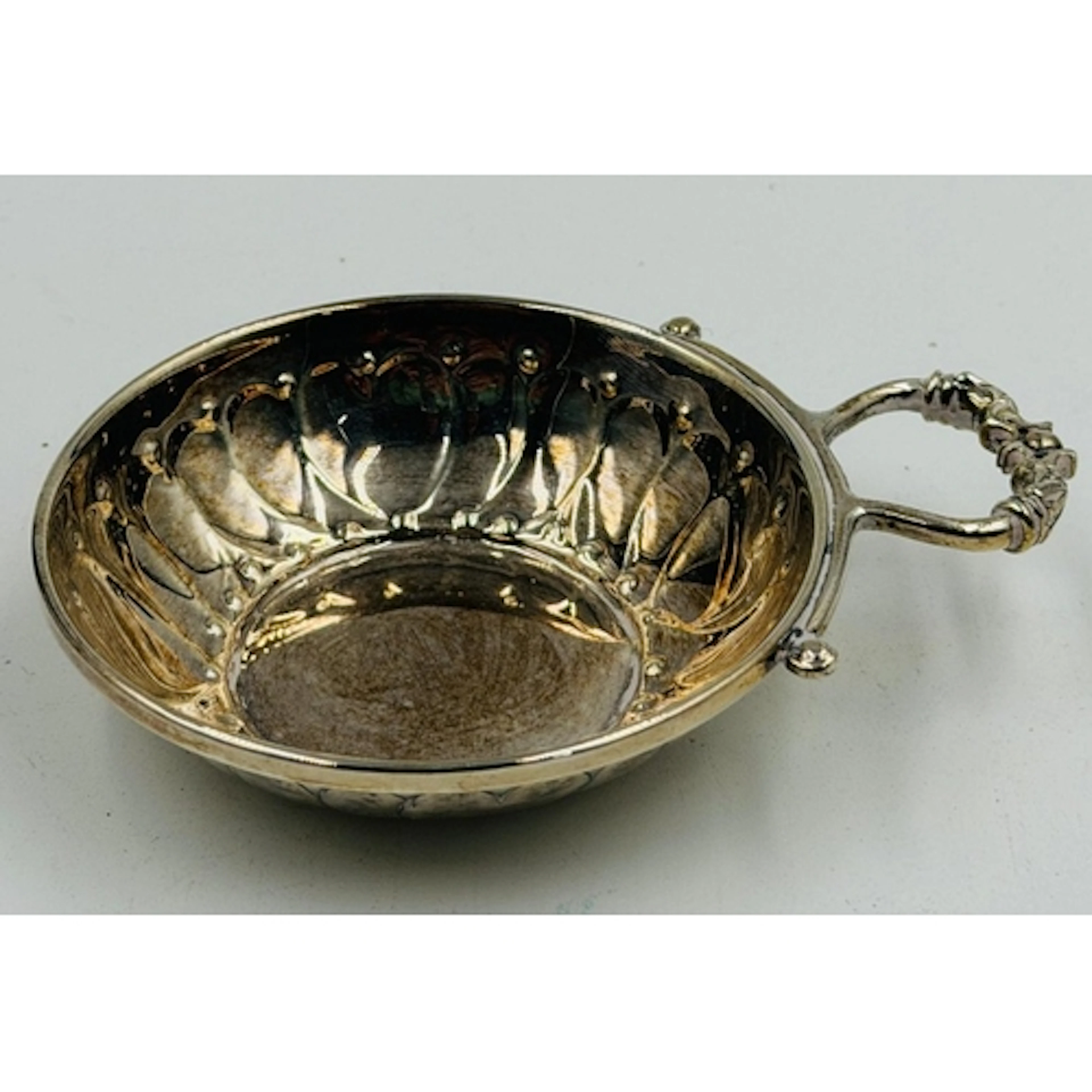 A hallmarked silver tastevin, Birmingham 1984 by J B Chatter...