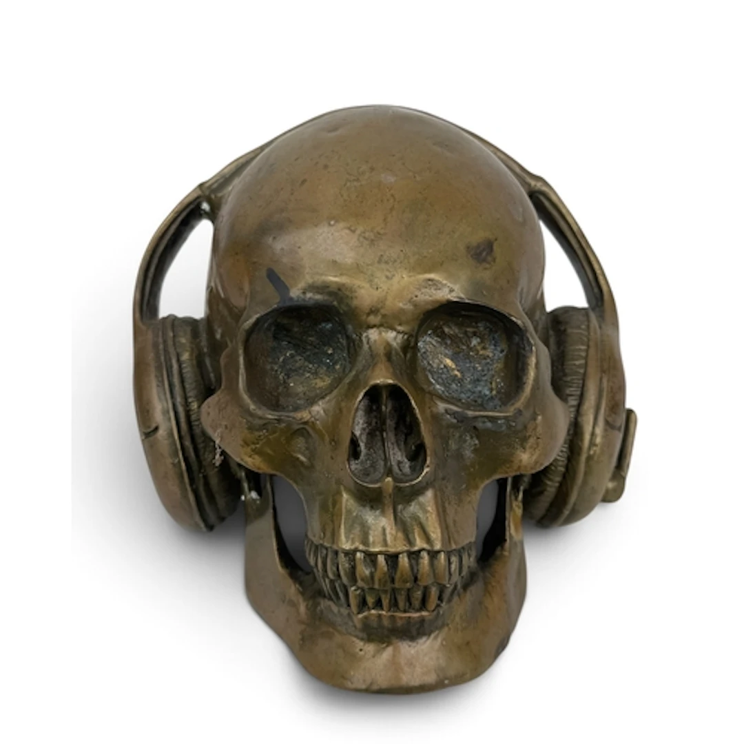 A BRONZE SKULL WEARING HEADPHONES