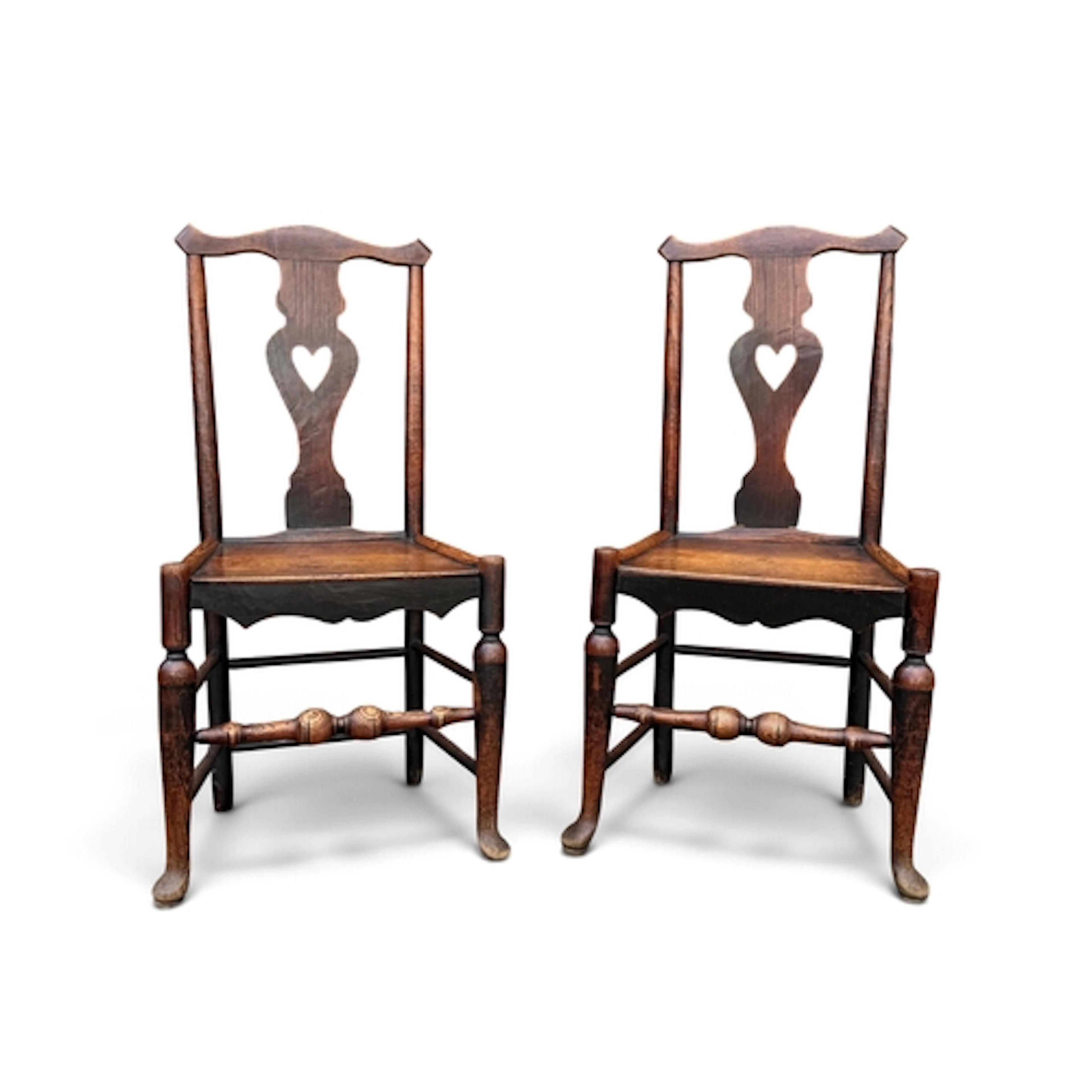 A PAIR OF 19TH CENTURY OAK HALL CHAIRS Each with central spl...