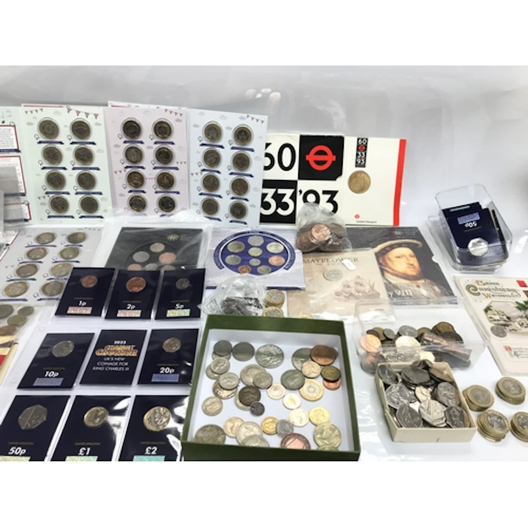A collection of coin sets and change checker coins including...