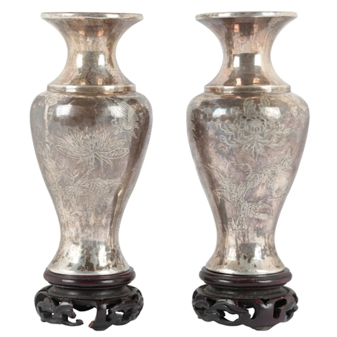 A pair of Chinese white metal vases and integral wood stands...