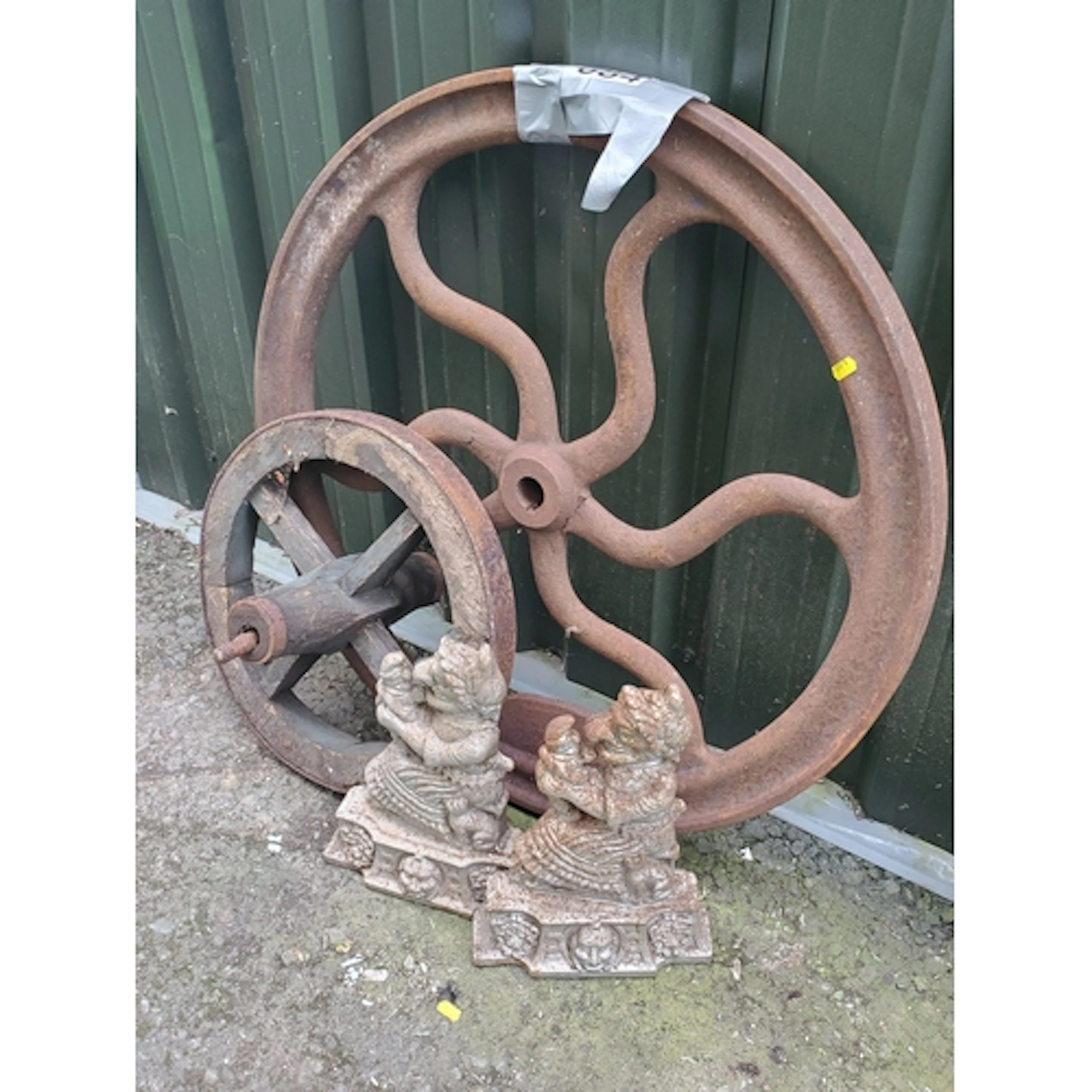 A cast iron Wheel, a wooden Wheel and a pair of Punch and Ju...