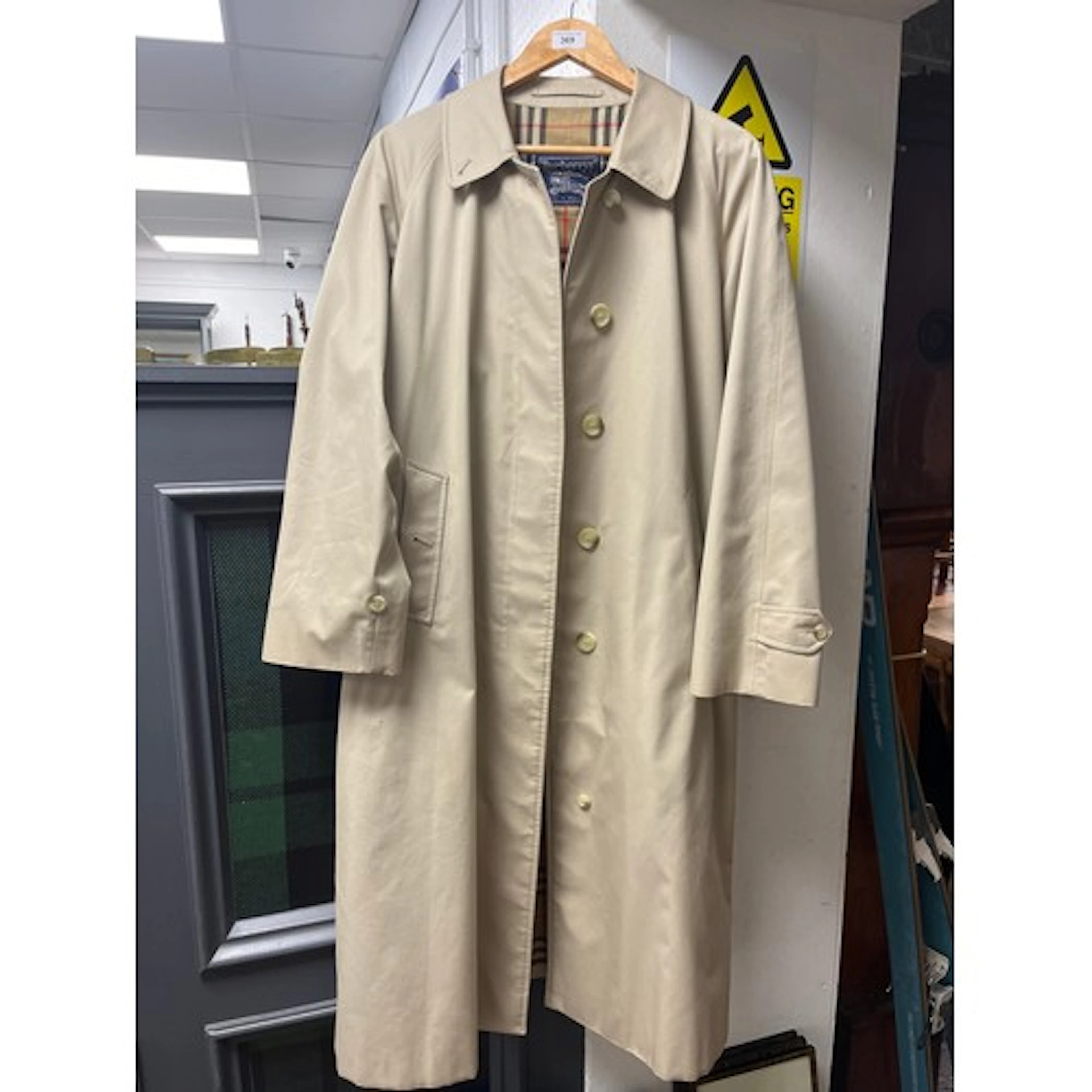 Burberry's ladies beige trench coat with plaid inside.