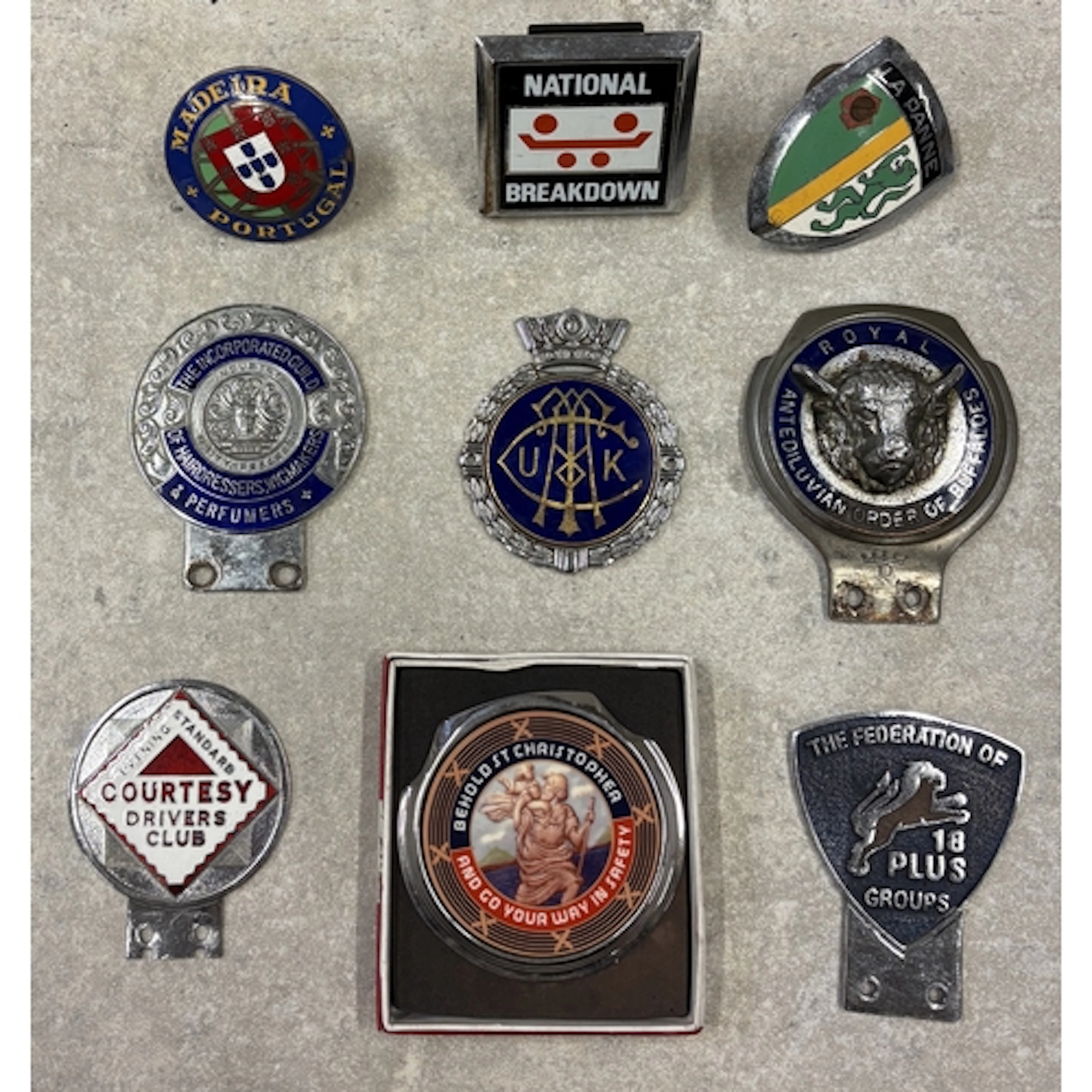 A collection of nine car badges to include The Incorporated ...