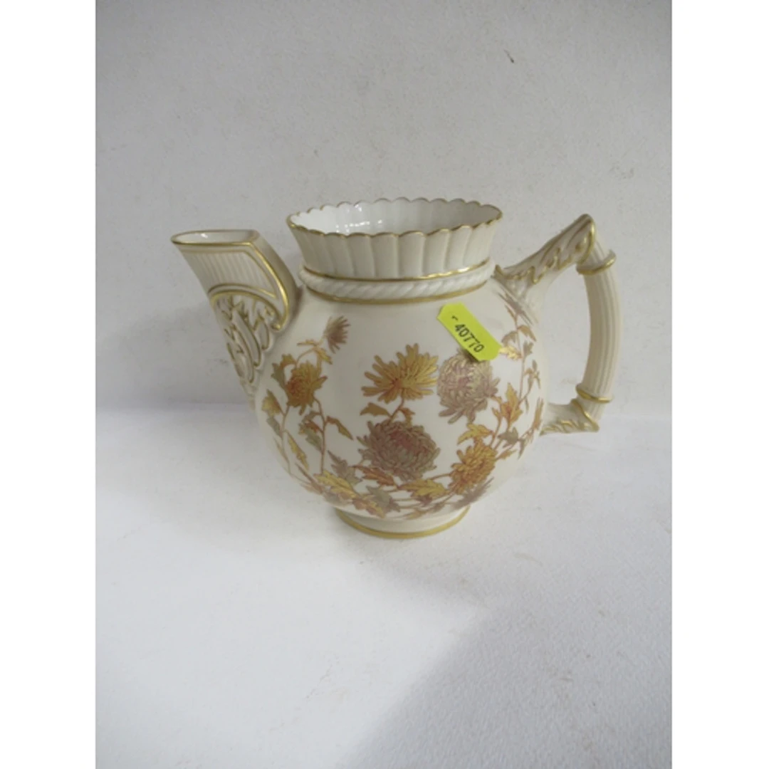 A Royal Worcester ivory jug, decorated with gilt flowers, he...
