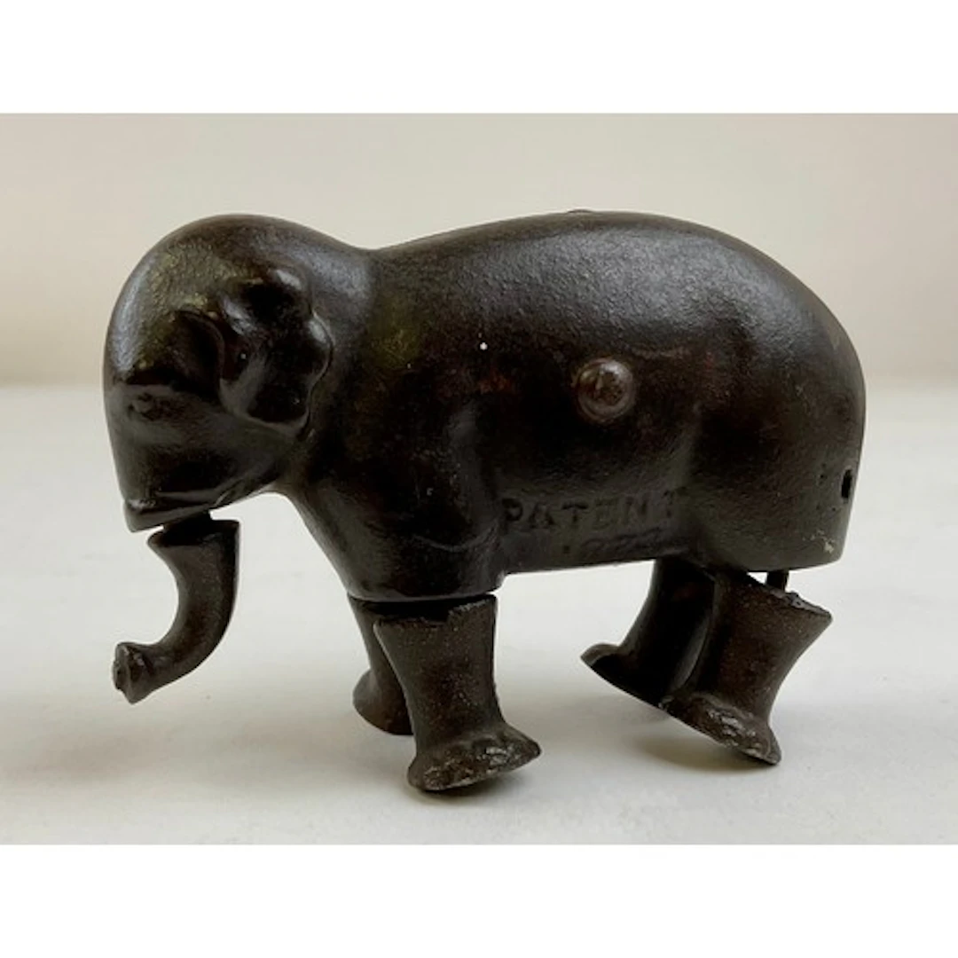 A late 19th century cast iron walking elephant toy, marked P...