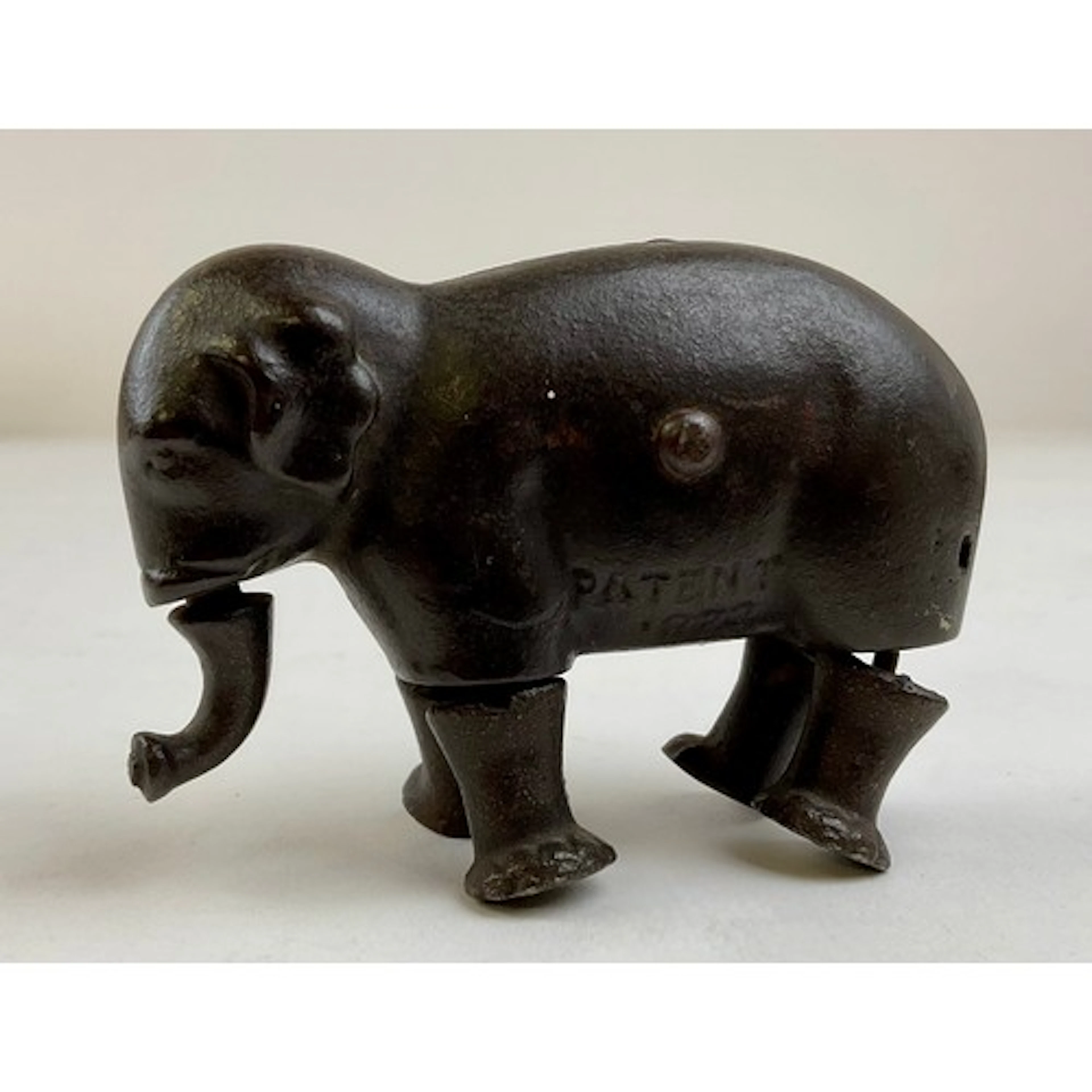 A late 19th century cast iron walking elephant toy, marked P...