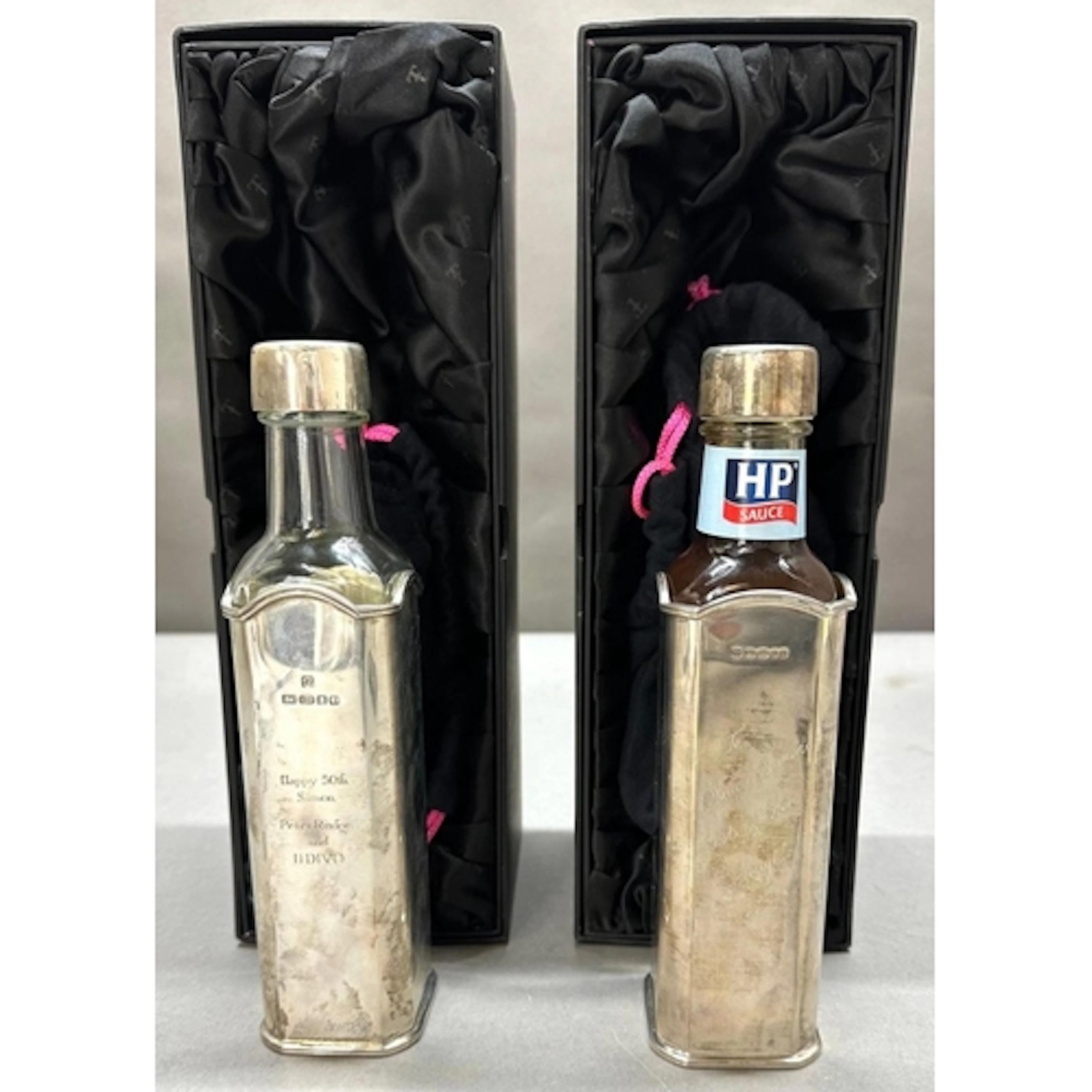 Two Theo Fennell silver, hallmarked HP Sauce bottle holders,...