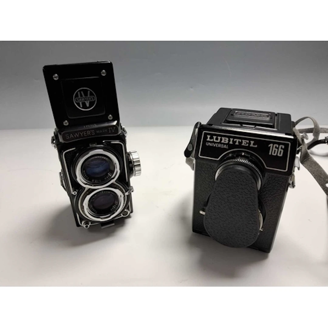 A SAWYER'S MARK IV CAMERA AND A NOMO LUBITEL UNIVERSAL 166 C...