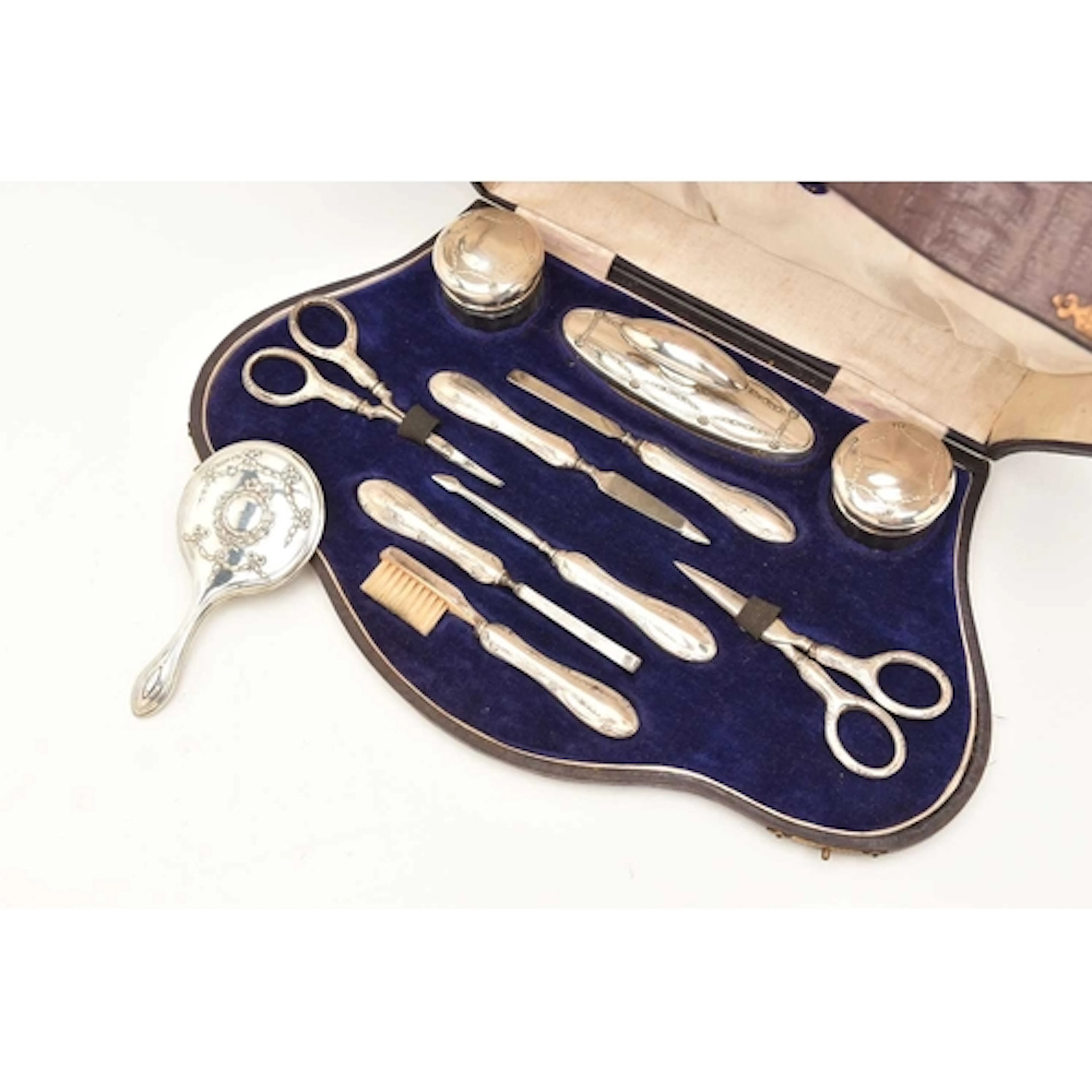 A CASED EARLY 20TH CENTURY SILVER MANICURE SET, comprising o...