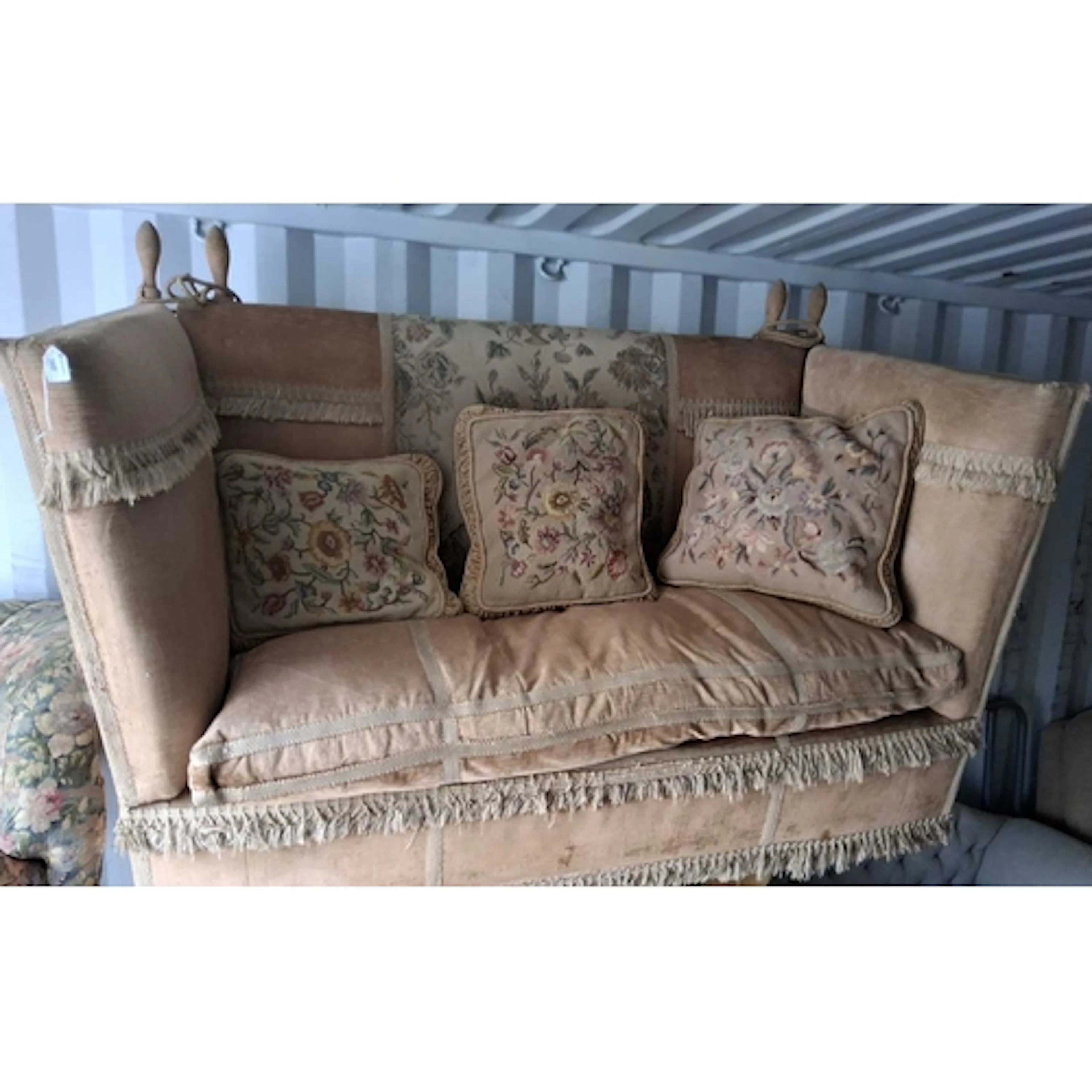 A ROSE GOLD COLOURED UPHOLSTERY KNOWLE SOFA, raised on brass...
