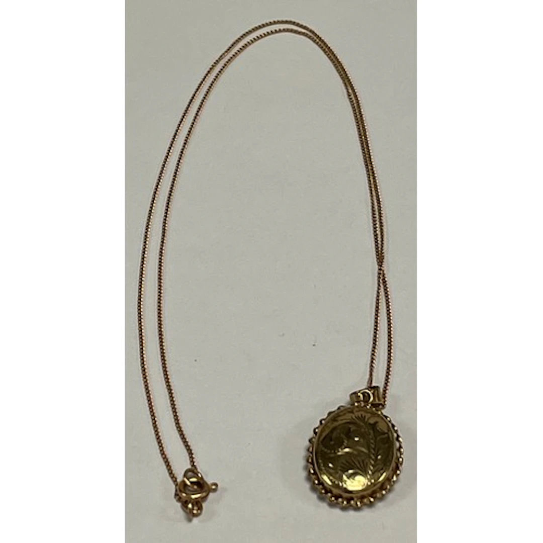 9ct gold locket pendant and chain, gross weight 5.4g.