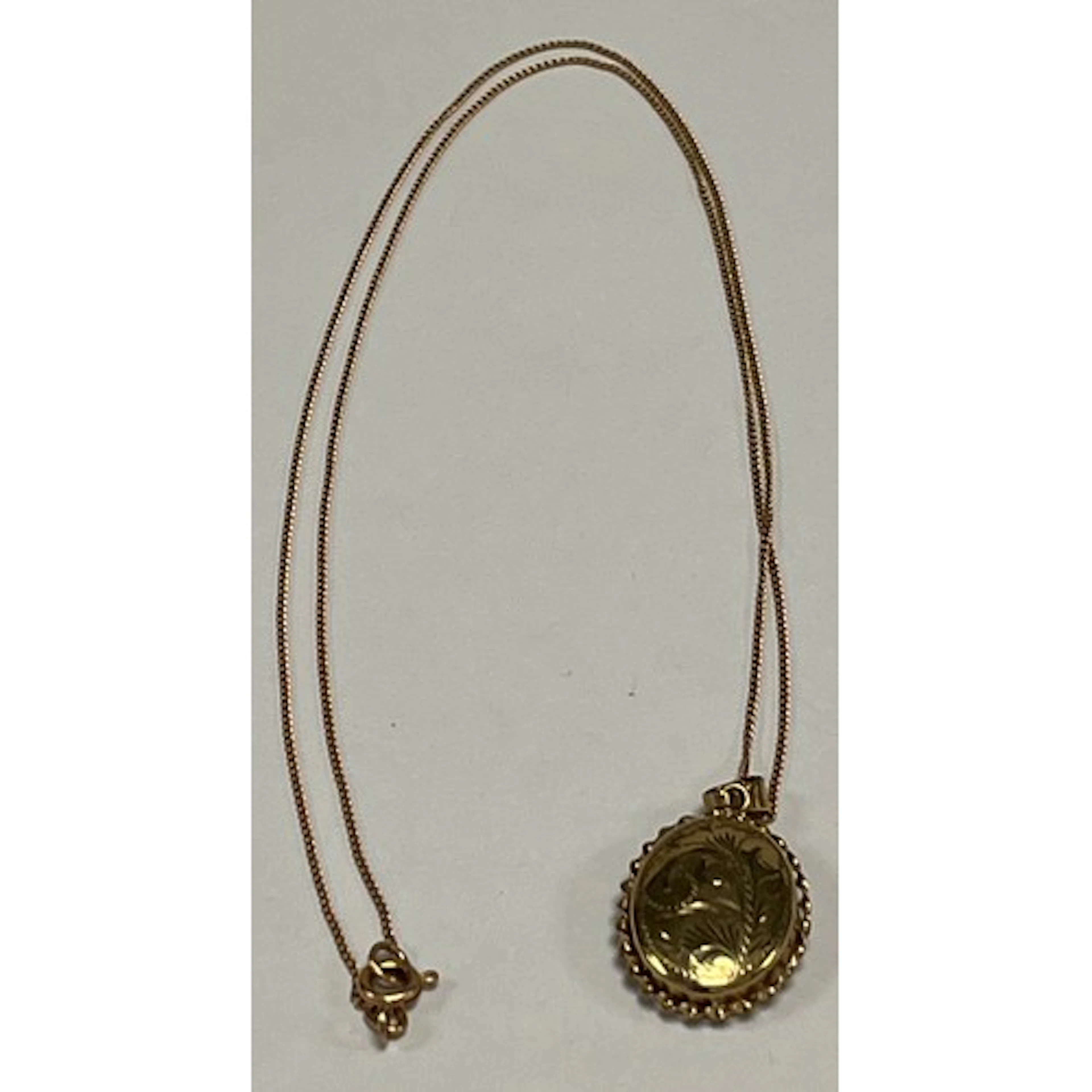 9ct gold locket pendant and chain, gross weight 5.4g.