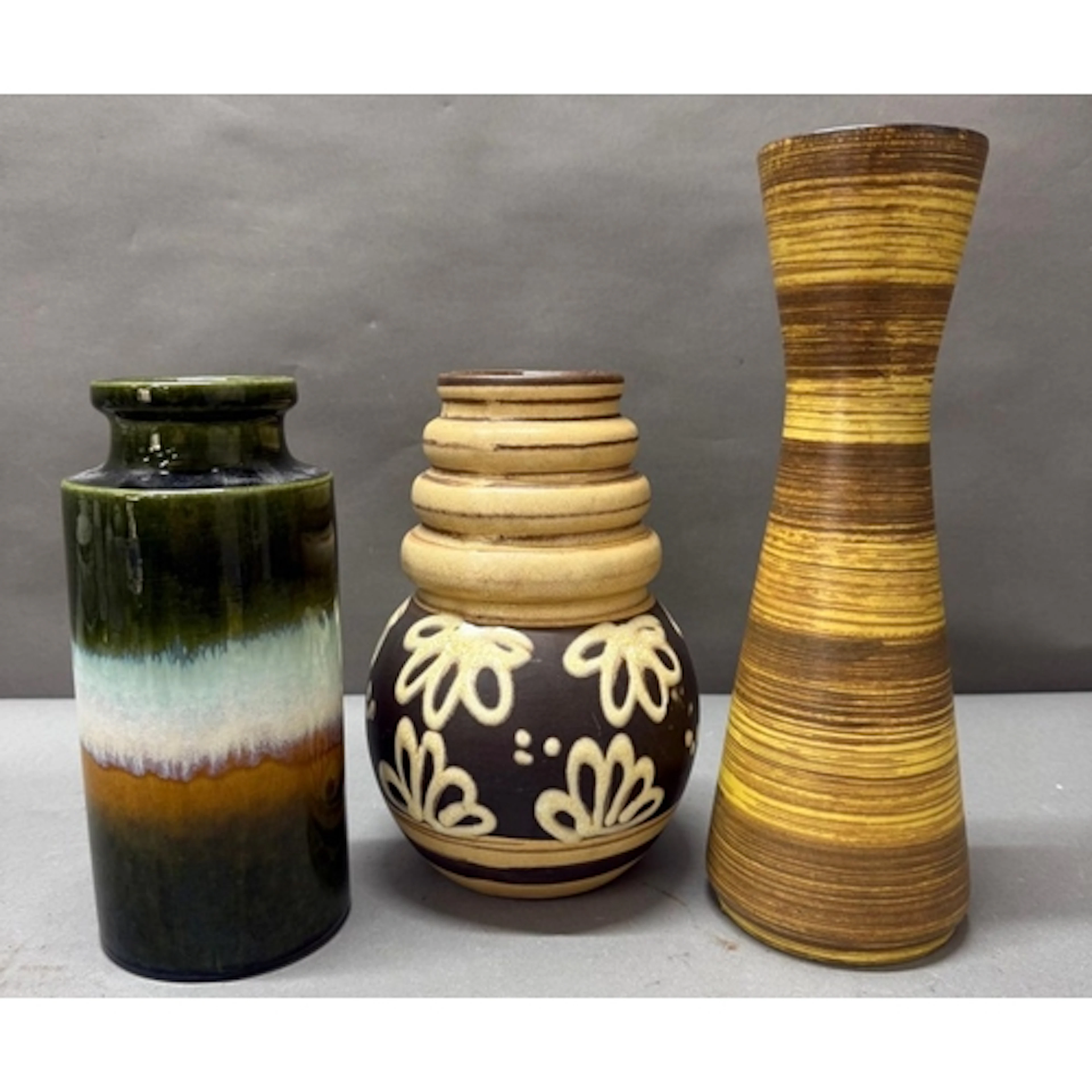 Three mid-century West German vases. Various styles and patt...