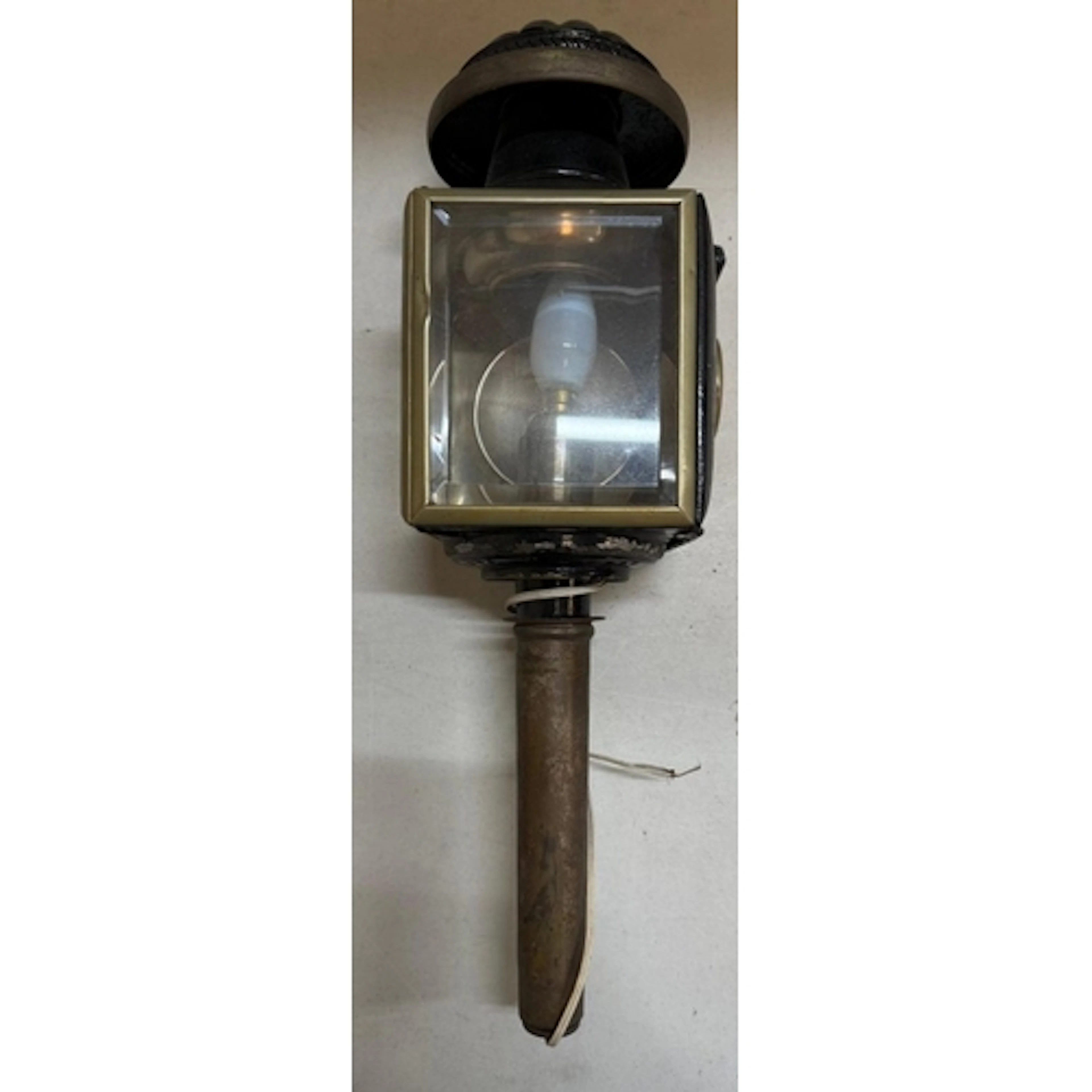 A brass carriage lamp convered to an electric wall light....