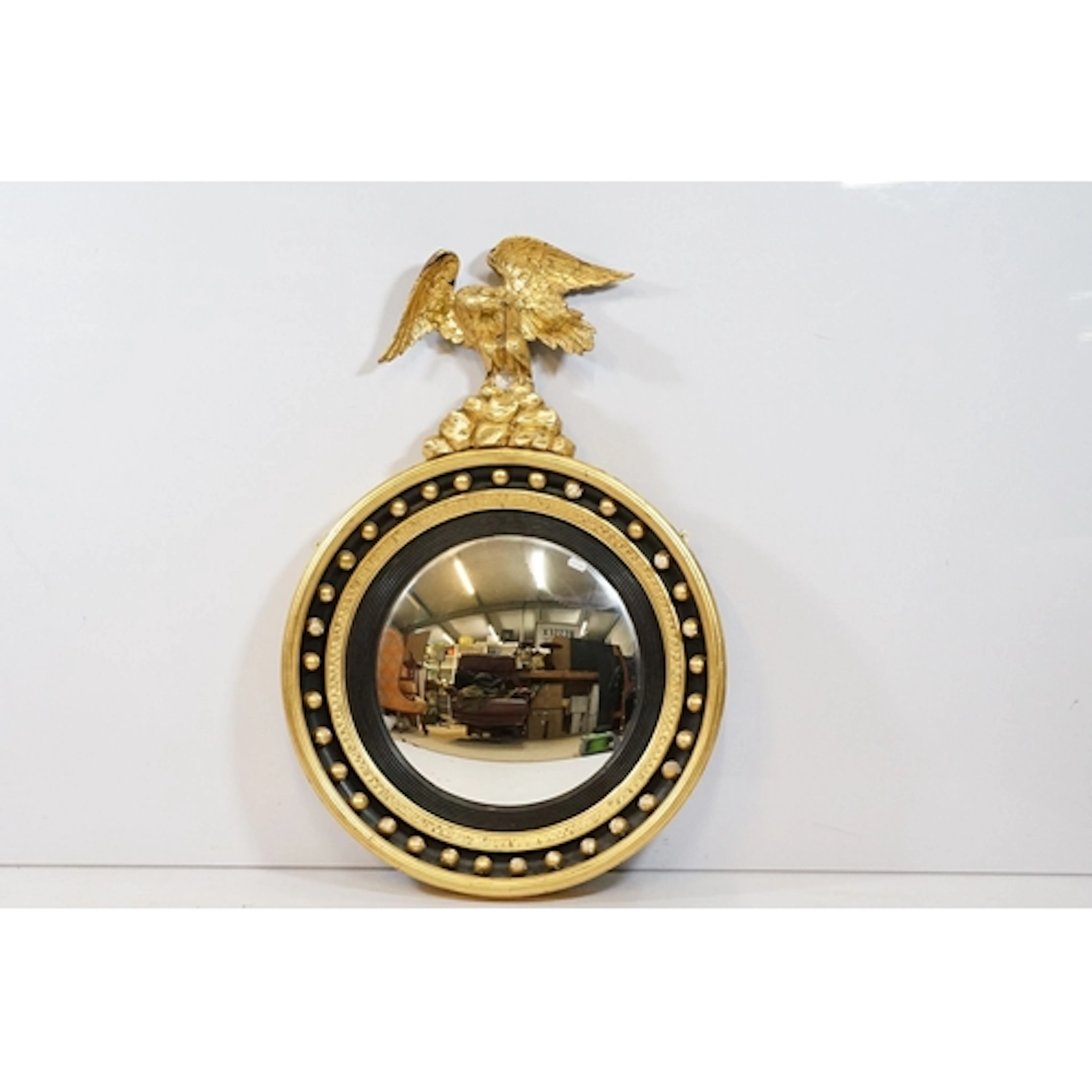 Regency type gilt framed convex wall mirror, having circular...
