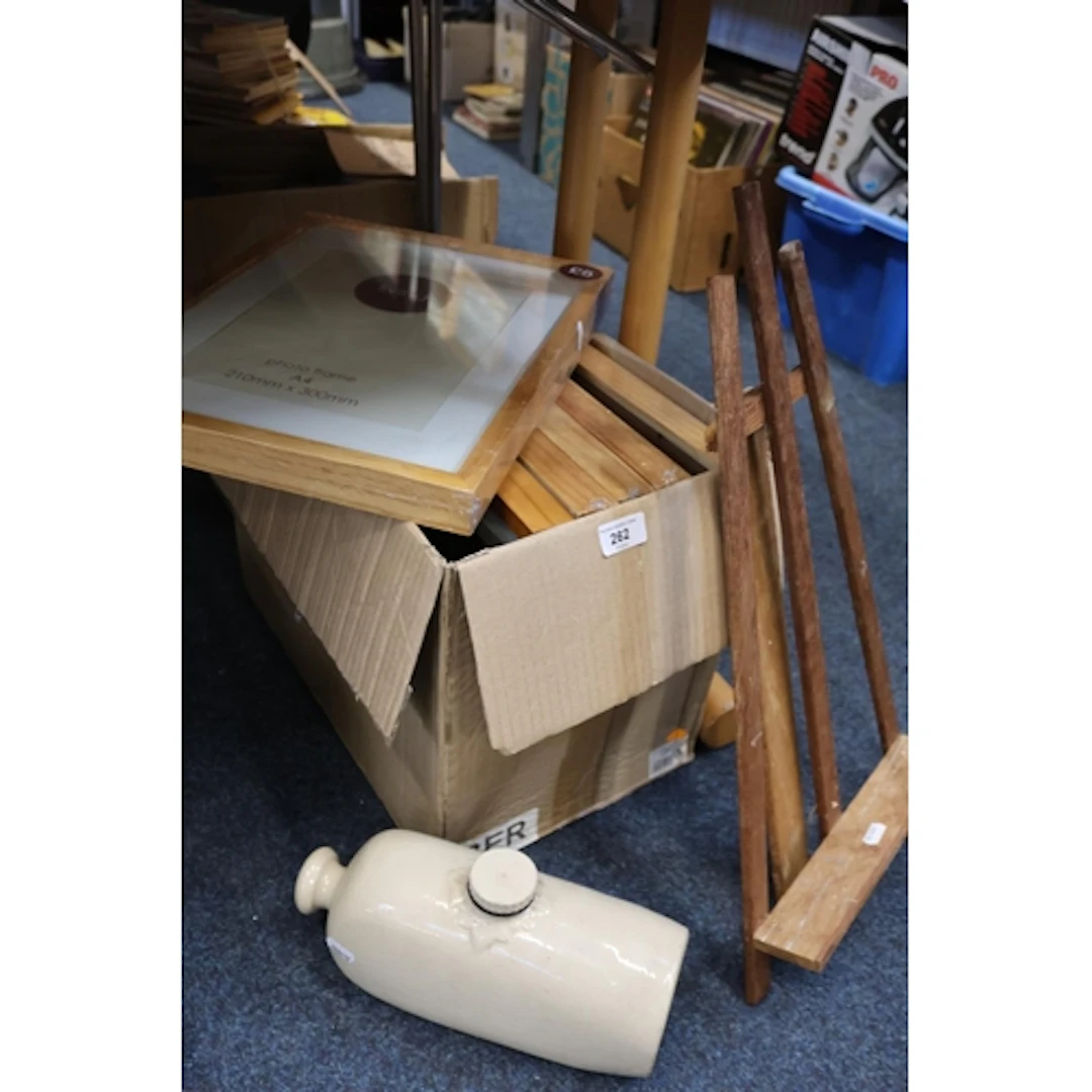 Photograph frames, a stoneware pig and a small easel.