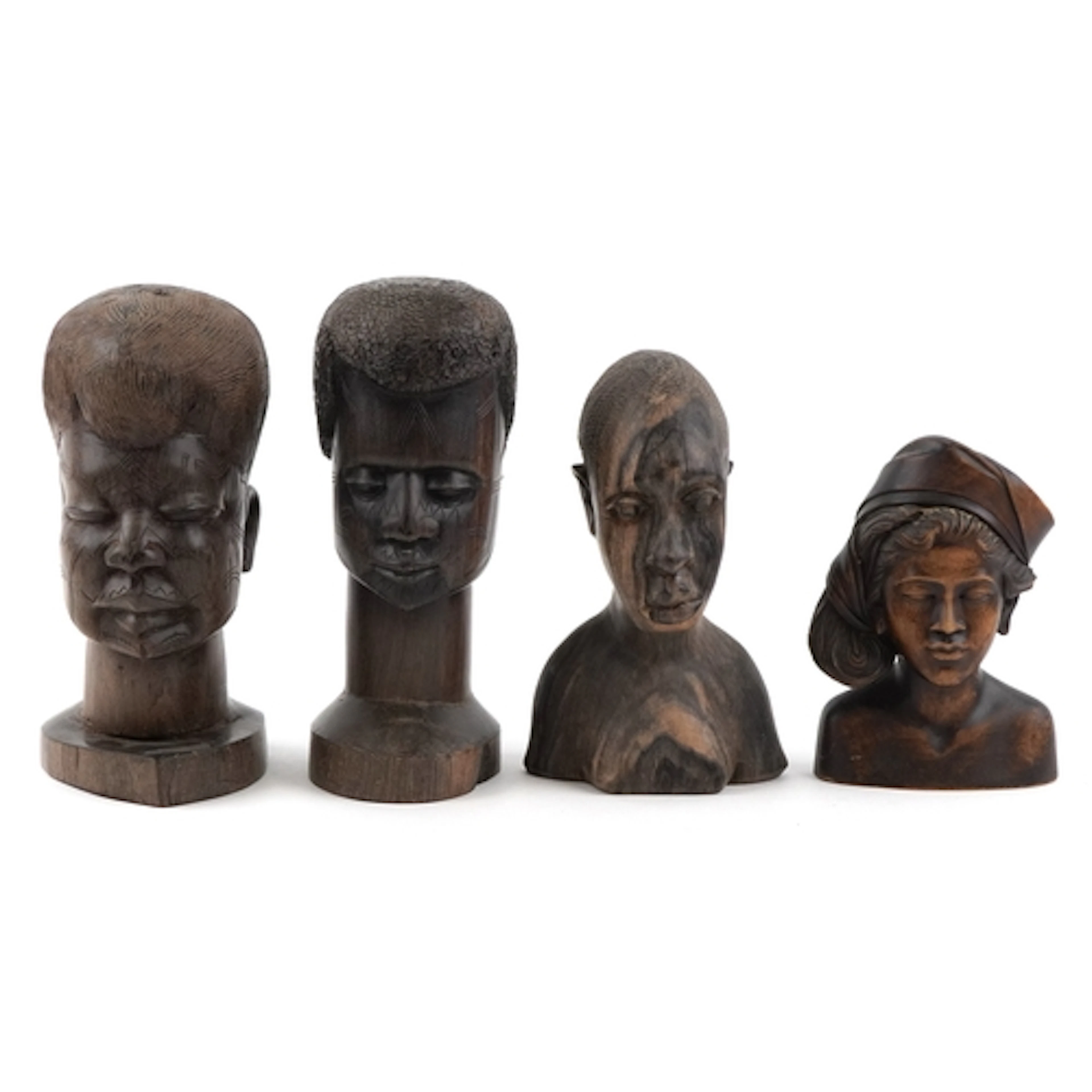 Four African ebonised carved wood busts, the largest 29cm hi...