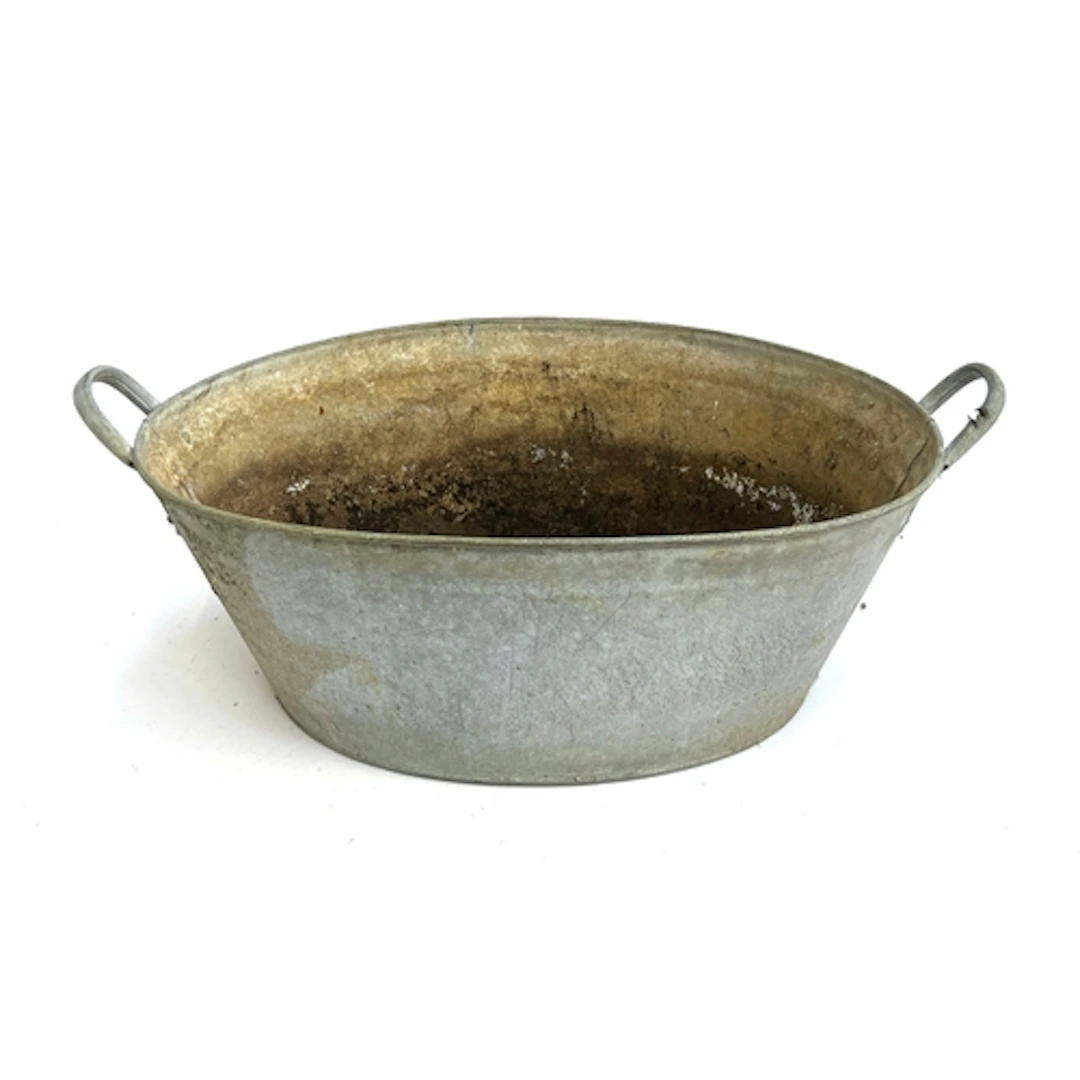 A twin handled galvanised tub with drilled holes, 72cmW